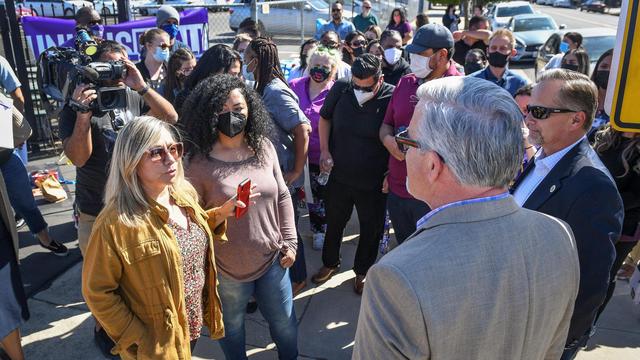 Fresno County social worker Lorraine Ramirez, left, discusses the situation for housing foster youth within the Child Protective Services office in downtown Fresno with Fresno County administrative officer Jean Rousseau, right, during a demonstration and news conference by social workers represented by SEIU Local 521.