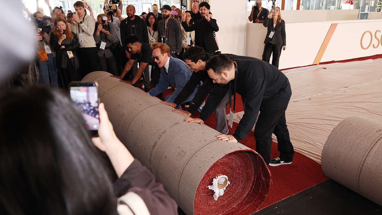 Conan O'Brien helps the crew during the 98th Oscars red carpet roll out at Ovation Hollywood on March 11, 2026 in Hollywood, California.