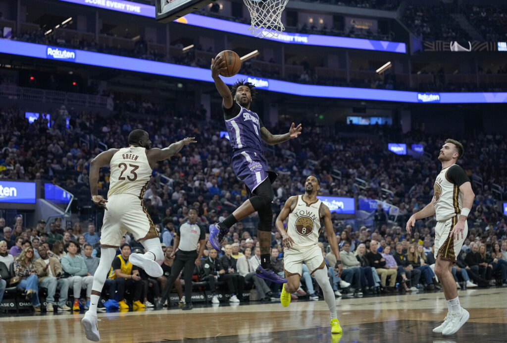 SAN FRANCISCO, CALIFORNIA - APRIL 07: Malik Monk #0 of the Sacramento Kings goes for a layup over Draymond Green #23 of the Golden State Warriors in the first half at Chase Center on April 07, 2026 in San Francisco, California. NOTE TO USER: User expressly acknowledges and agrees that, by downloading and or using this photograph, User is consenting to the terms and conditions of the Getty Images License Agreement. (Photo by Thearon W. Henderson/Getty Images)