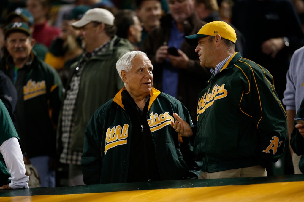 Owner Lew Wolff and Owner John  Fisher of the Oakland Athletics talk in the stands during the game against the Houston Astros at the Oakland Coliseum on July 19, 2016 in Oakland, California.
