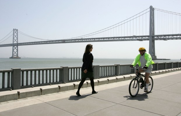 A bicyclist rides along the Embarcadero near the San Francisco Bay Bridge. (Justin Sullivan -- Getty Images)