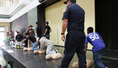 Students learning CPR with mannequins