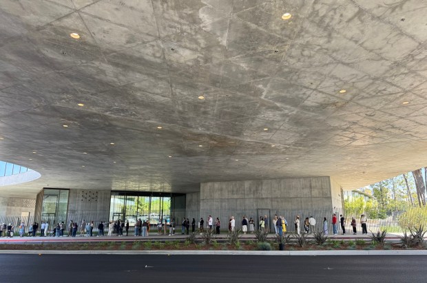 A line to enter LACMA's new Geffen Galleries forms Sunday morning in the shade of the museum itself, which spans Wilshire Boulevard in Los Angeles and is elevated 30 feet above the pavement. (Photo by David Allen, Inland Valley Daily Bulletin/SCNG)