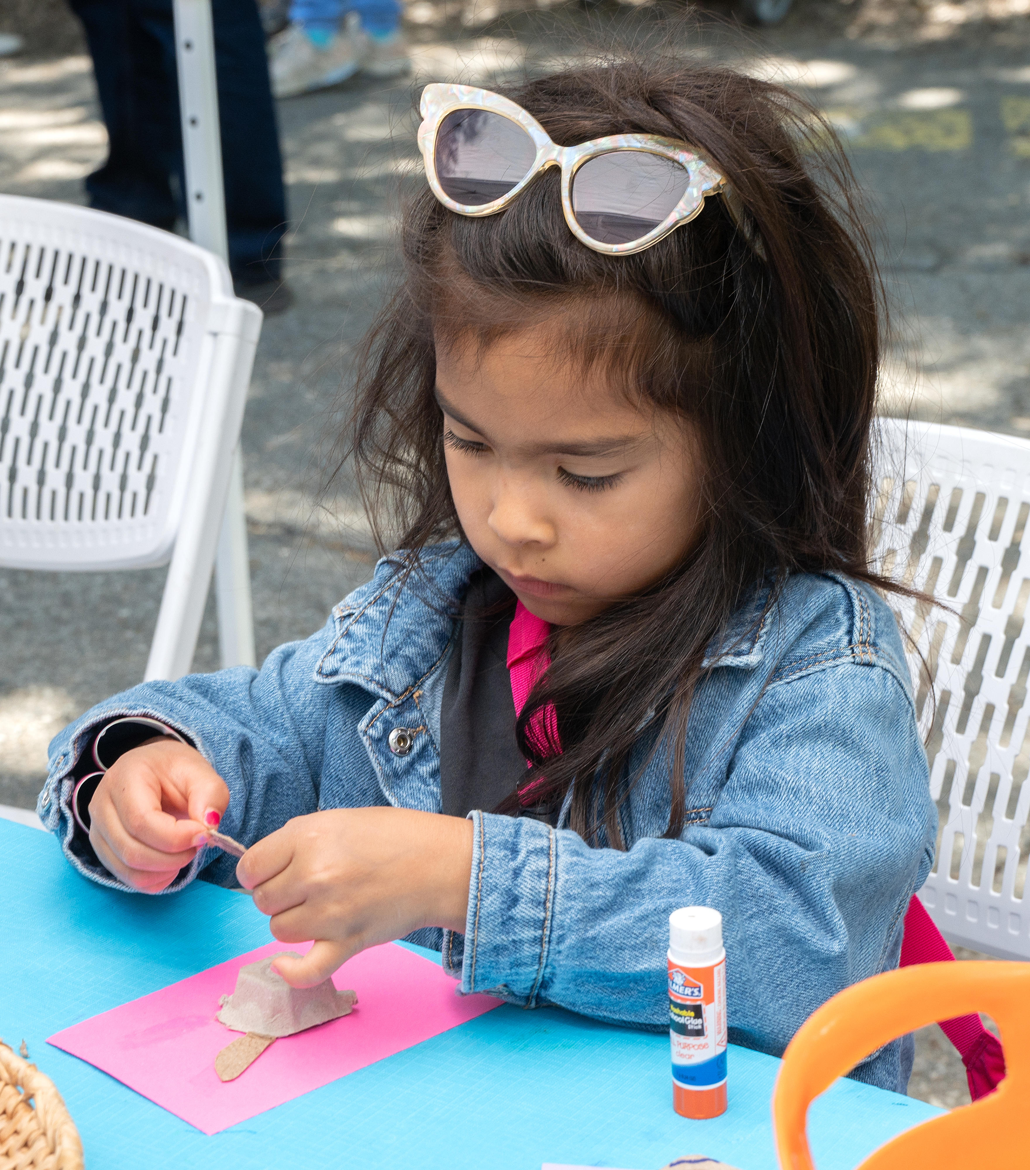 Four-year-old Emi Chan works on a craft during the grand...
