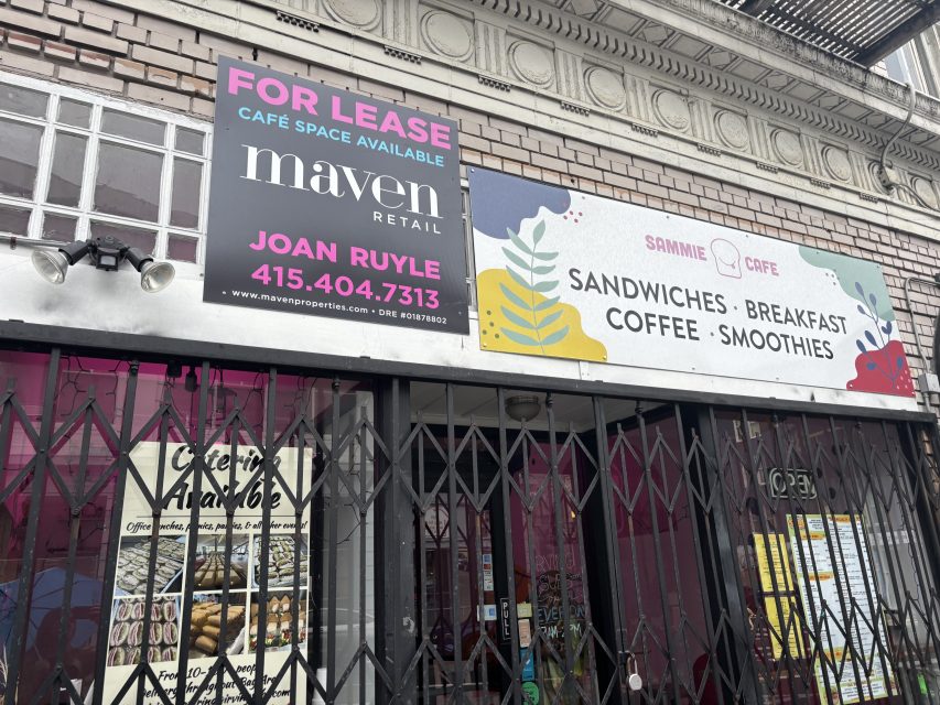 Storefront with a "For Lease" sign above a café entrance, advertising available café space, next to a café sign listing sandwiches, breakfast, coffee, and smoothies.