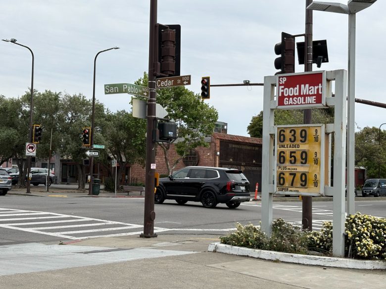 The price display outside a gas station shows a gallon of regular unleaded costs $6.40 cents.