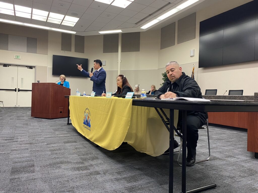 Candidates sitting behind a table.