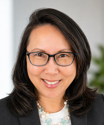 woman with dark hair wearing glasses