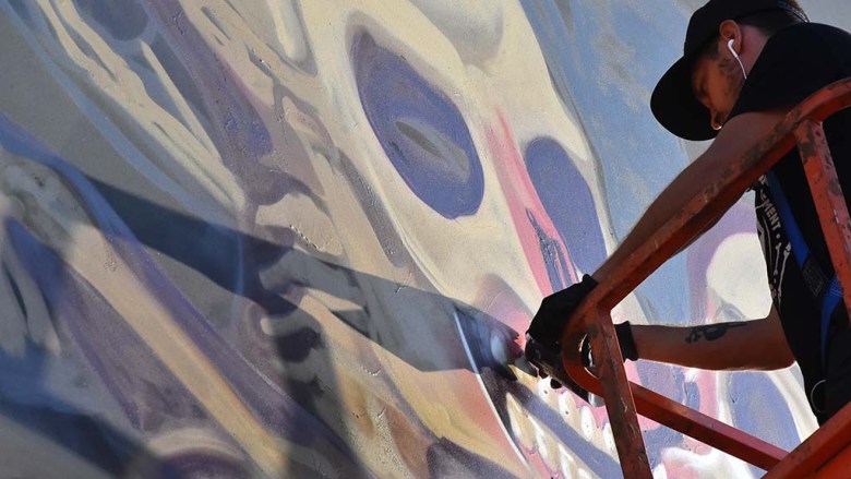 An artist puts finishing touches on a painting at KAABOO Del Mar.