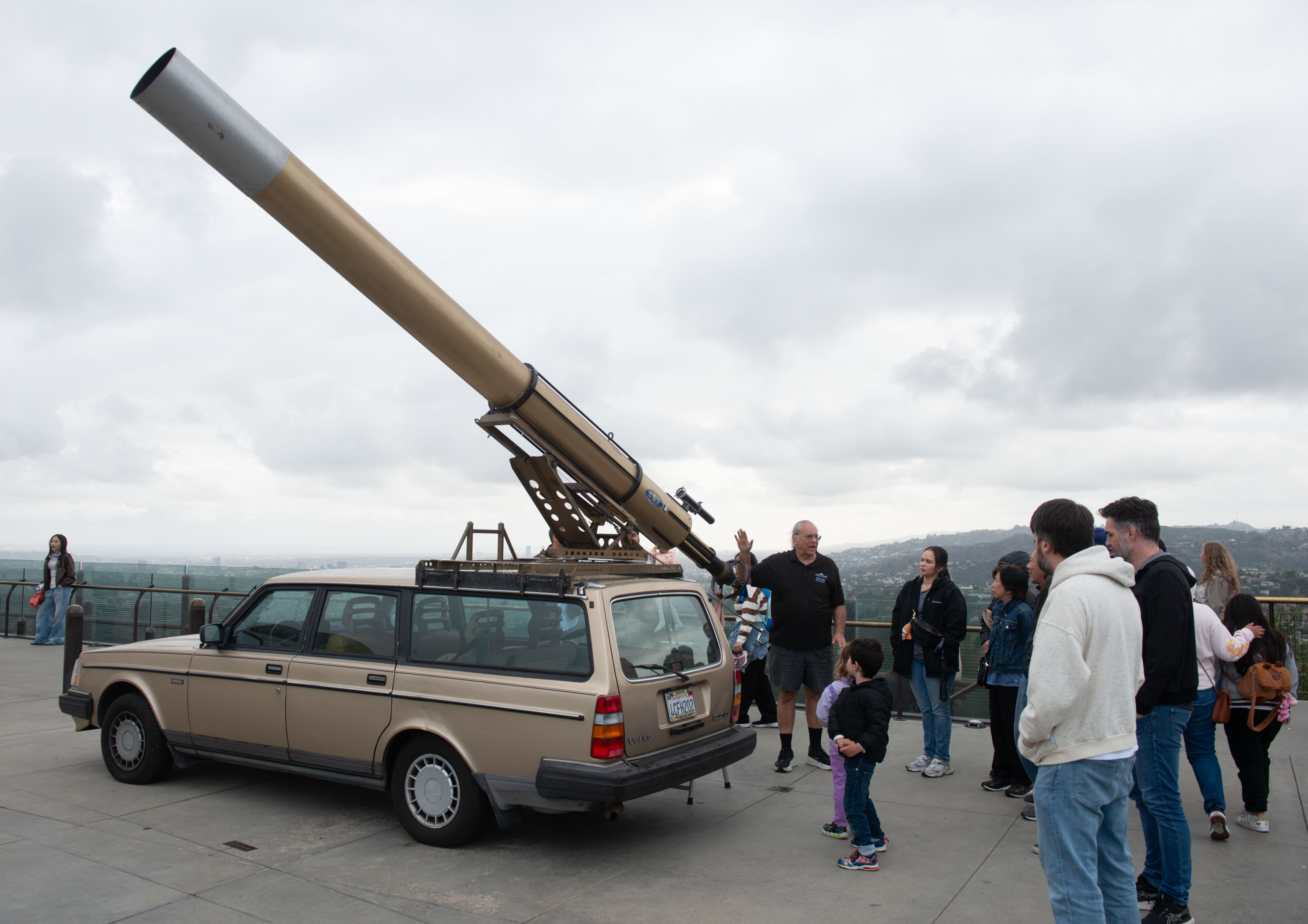 Jeff Schroeder (center) talks to visitors about the telescope he...