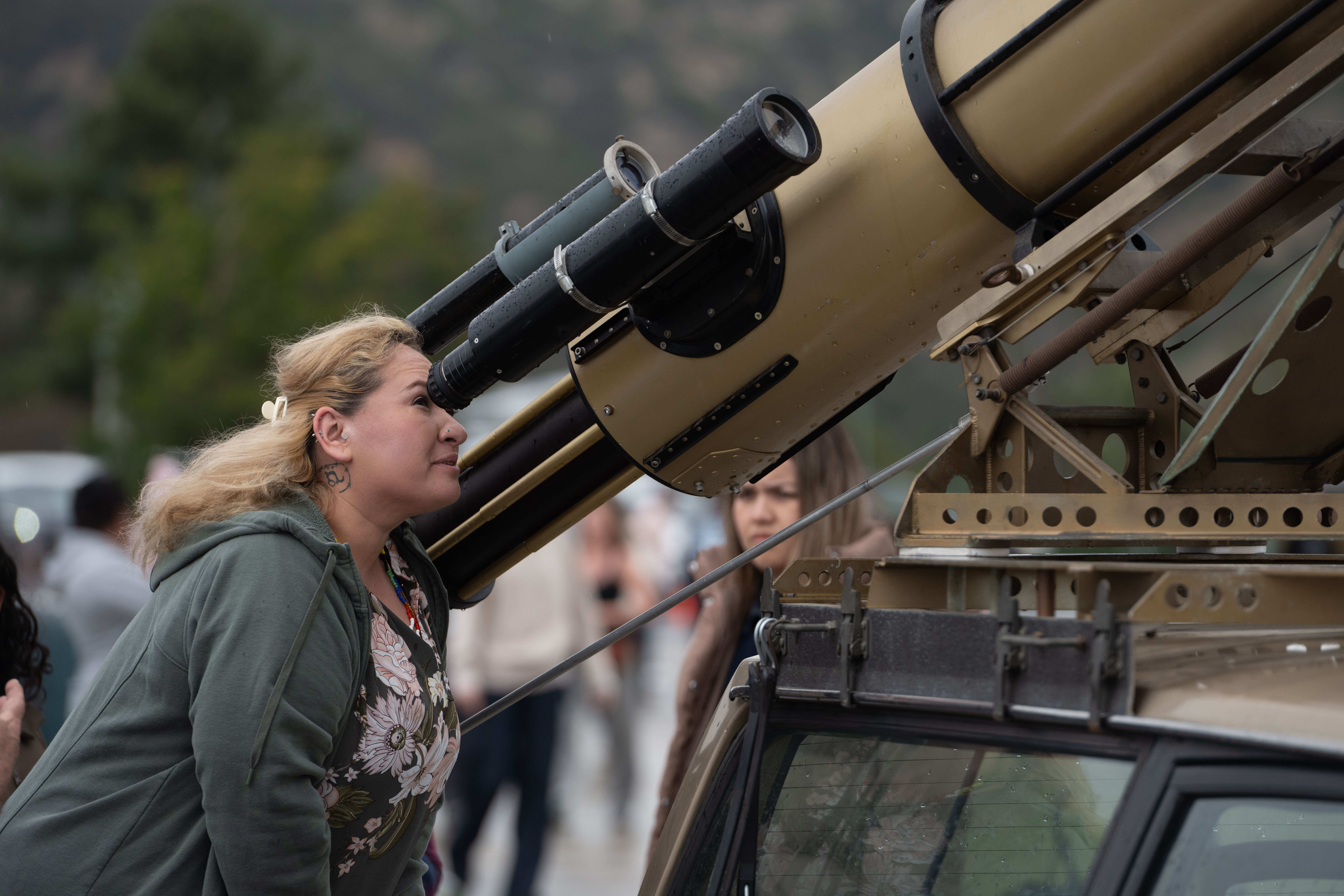Cynthia Salguero looks through the finder scope of one of...