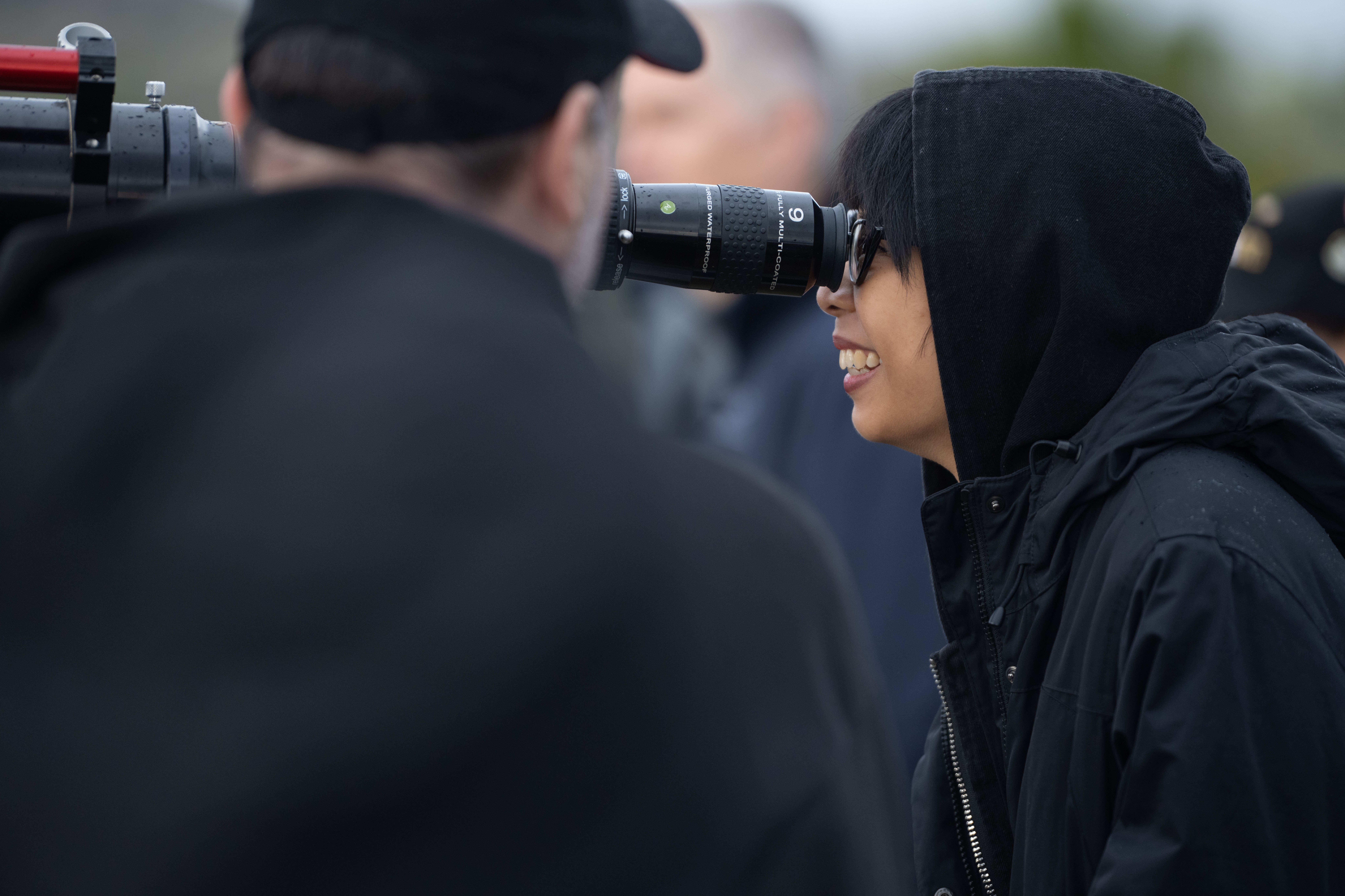 Jackie Cadiente looks through a telescope for a closer view...
