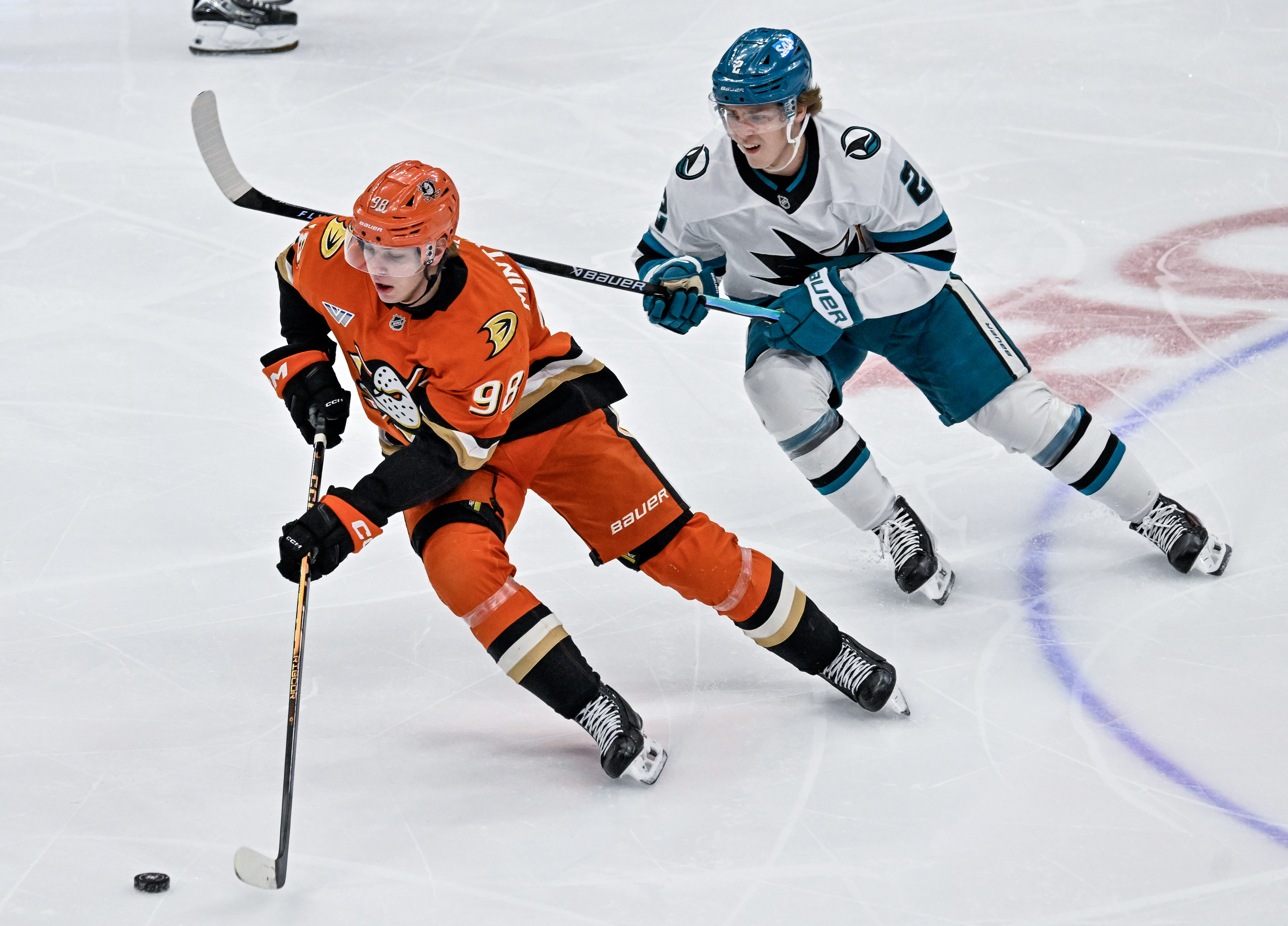 The Ducks’ Pavel Mintyukov, left, controls the puck in front...