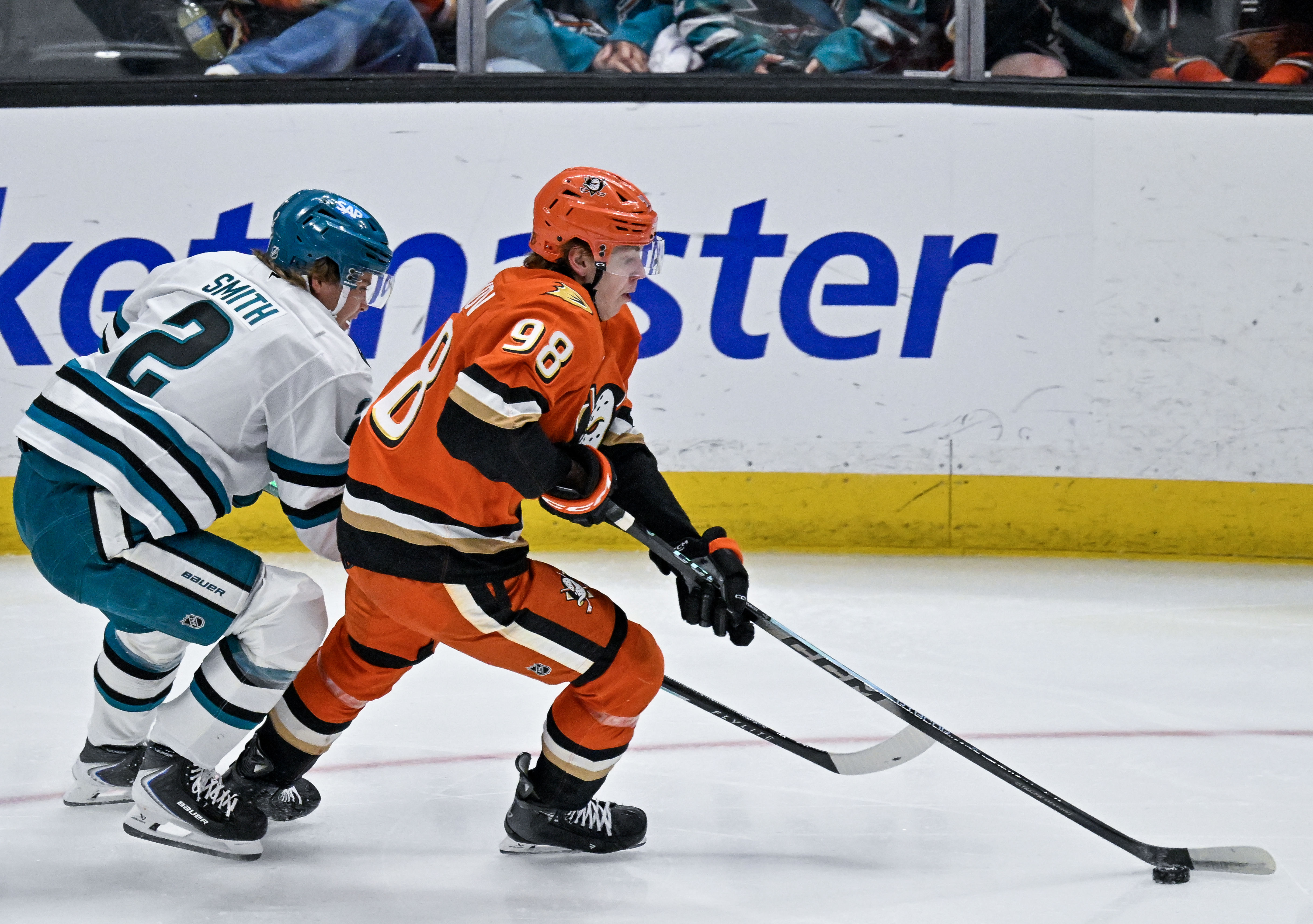 The Ducks’ Pavel Mintyukov, right, controls the puck during the...