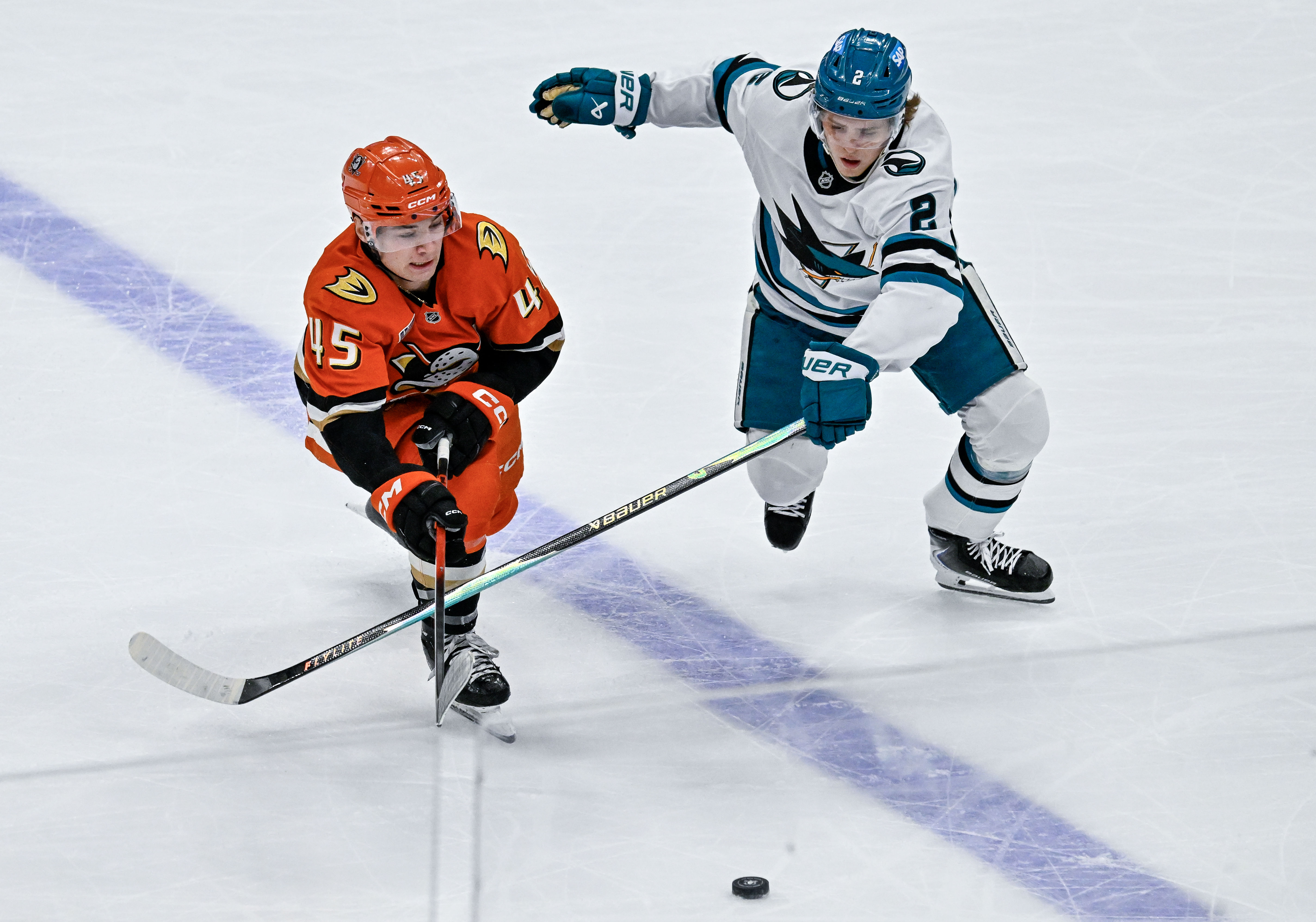 The Ducks’ Beckett Sennecke, left, and the San Jose Sharks’...
