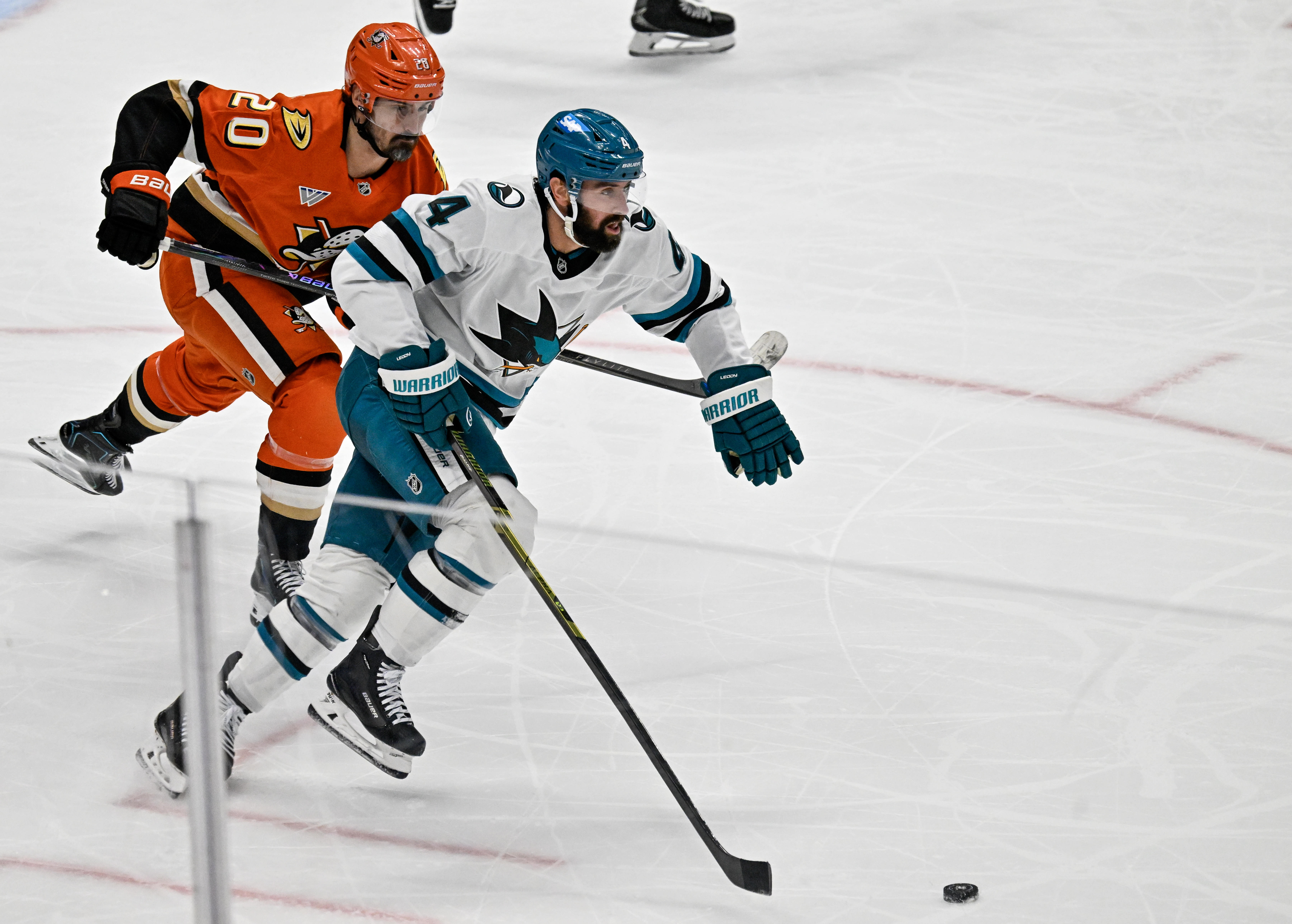 The San Jose Sharks’ Nick Leddy, front, controls the puck...