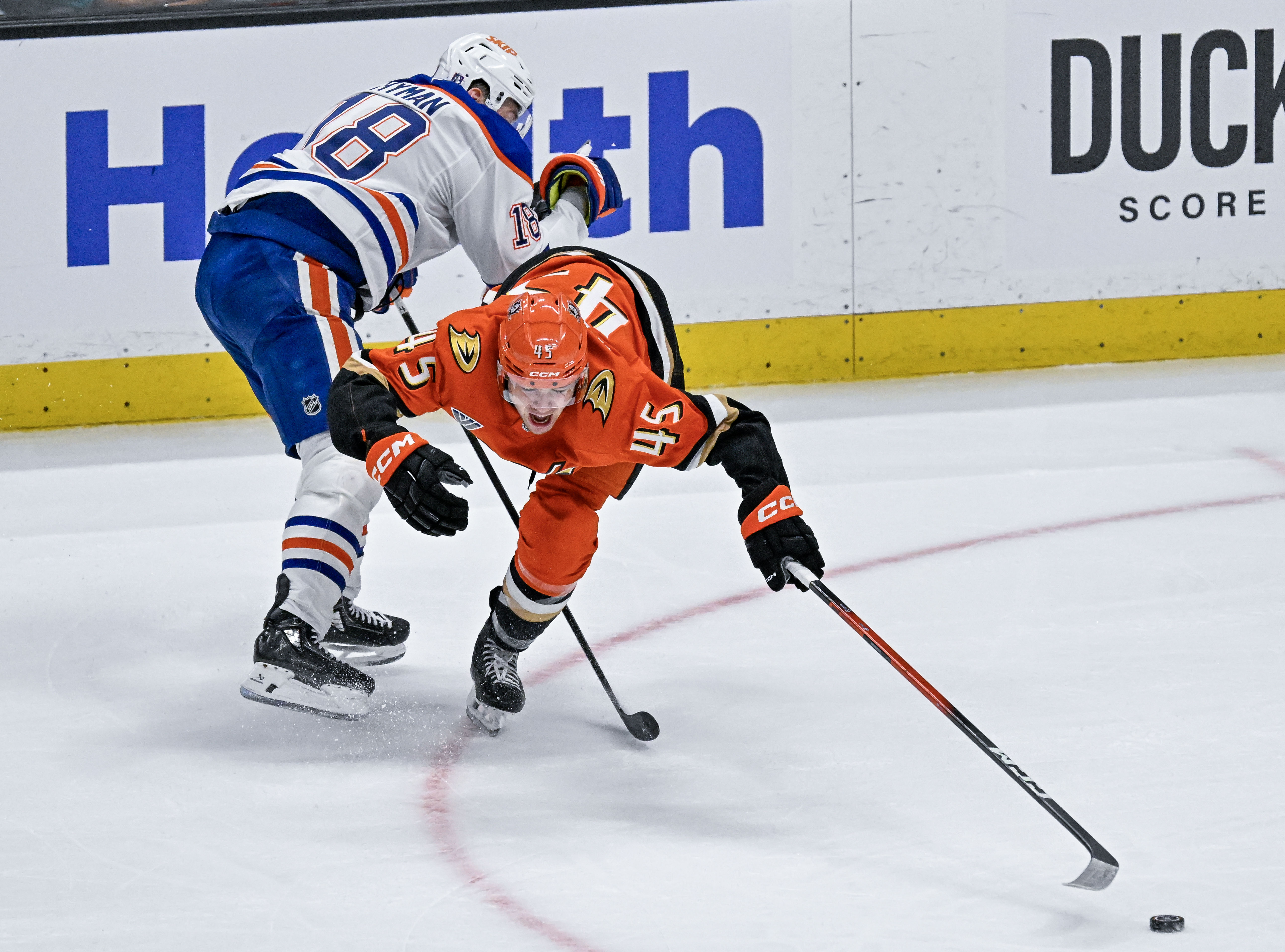 The Oilers Zach Hyman (18), left, upends the Ducksâ Beckett...
