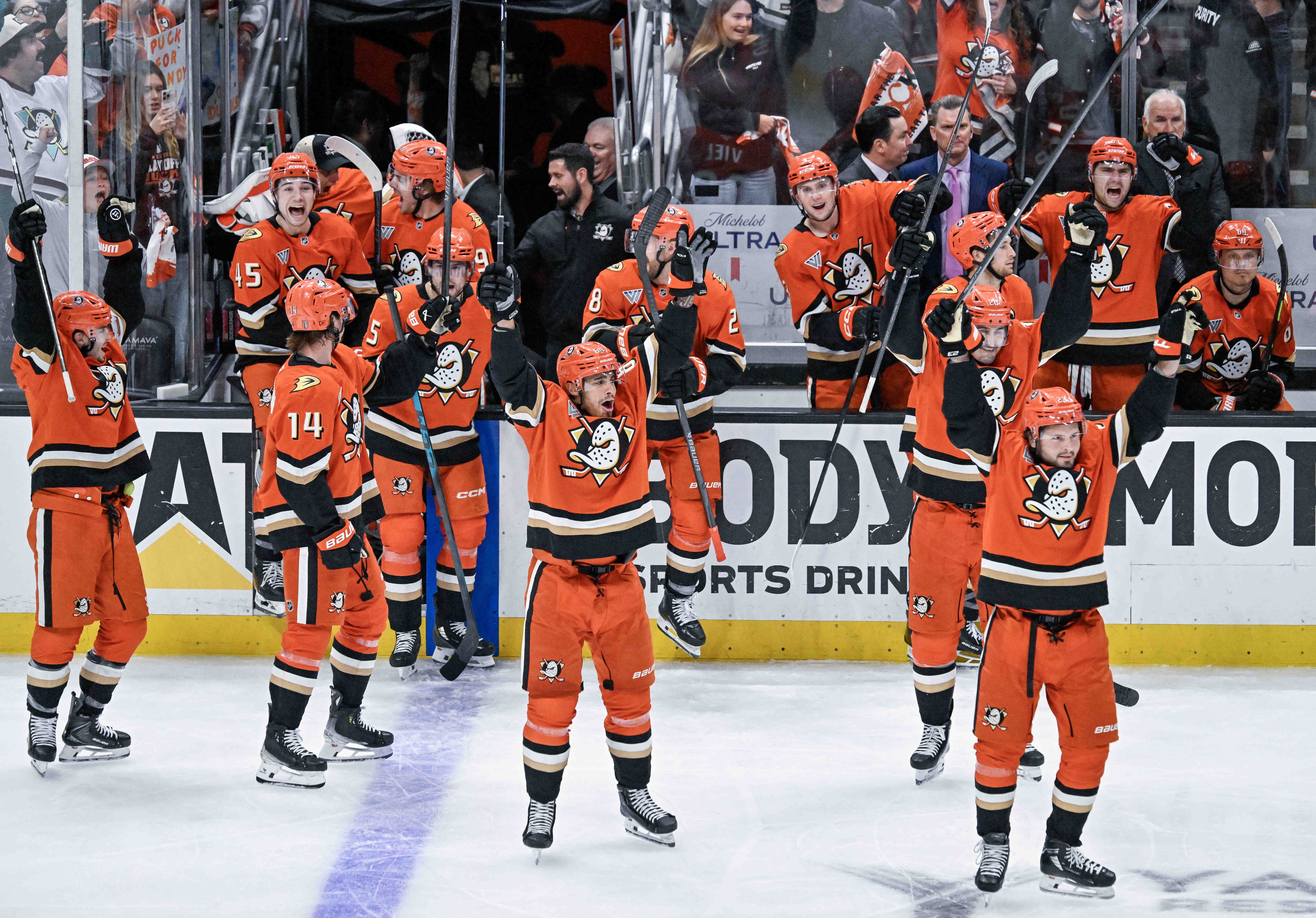 Ducks players celebrate their overtime 4-3 win, after a lengthy...
