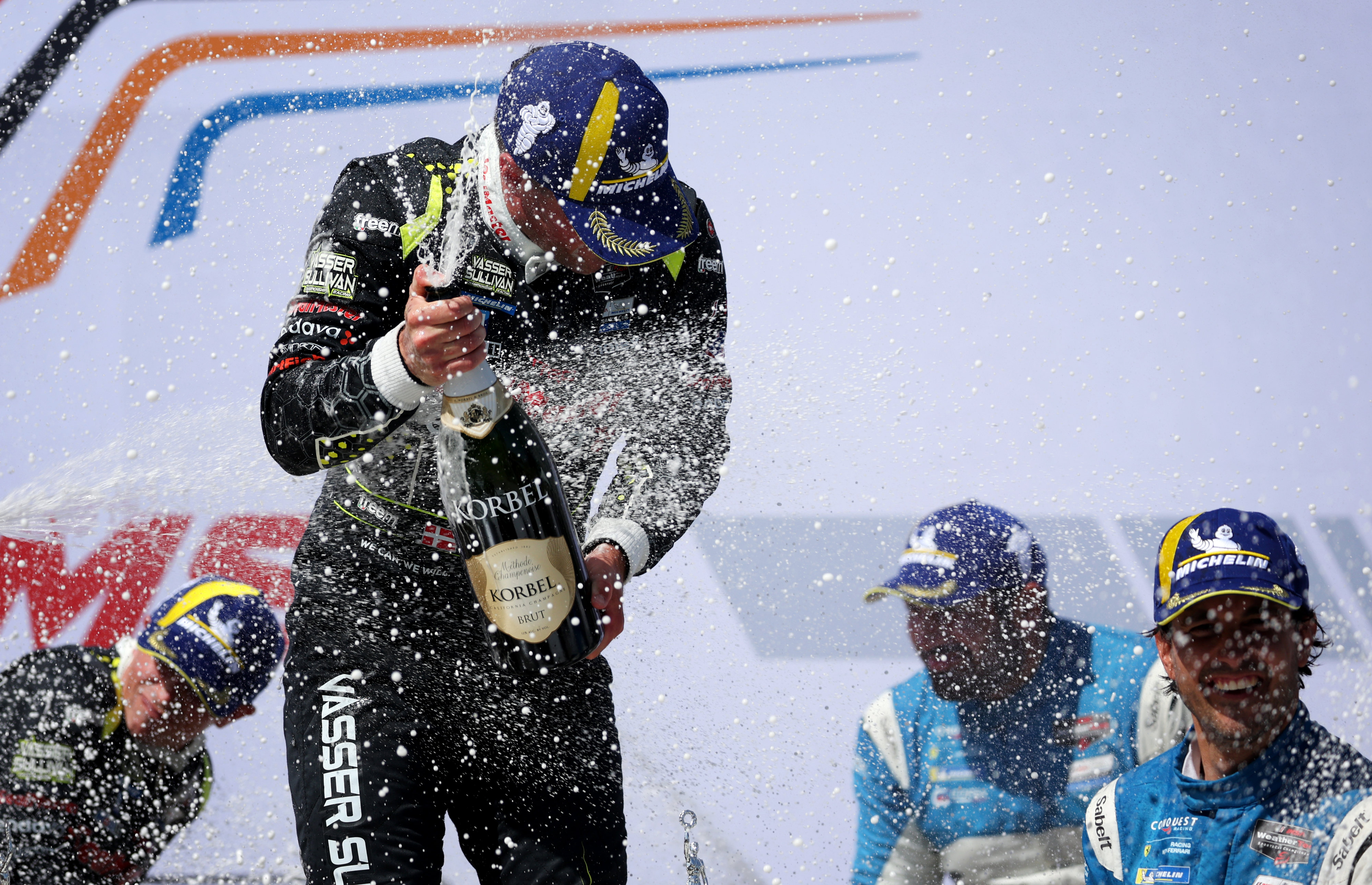 Vasser Sullivan Racing driver Benjamin Pedersen, center left, celebrates after...
