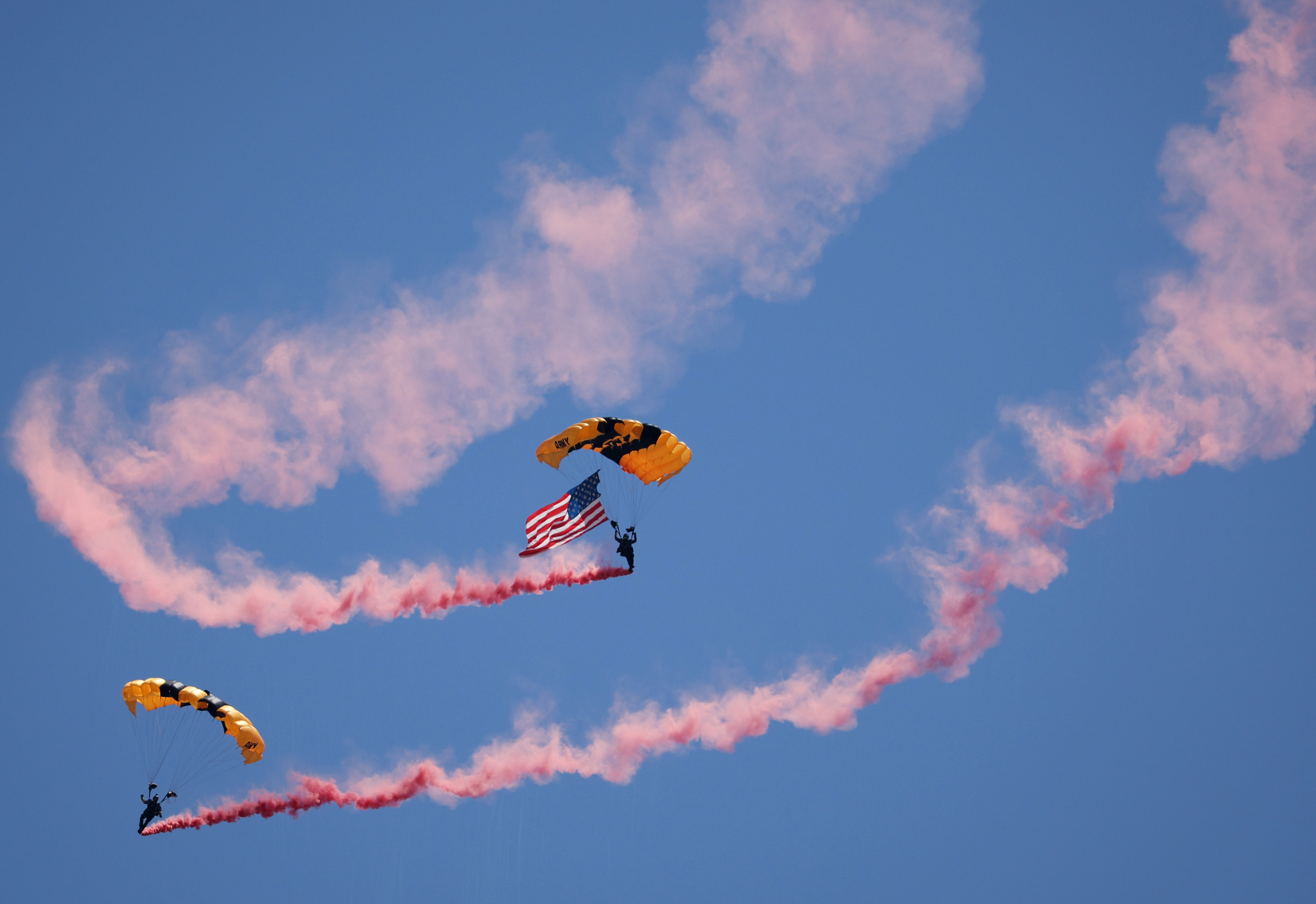 Members of the U.S. Army Golden Knights parachute onto the...