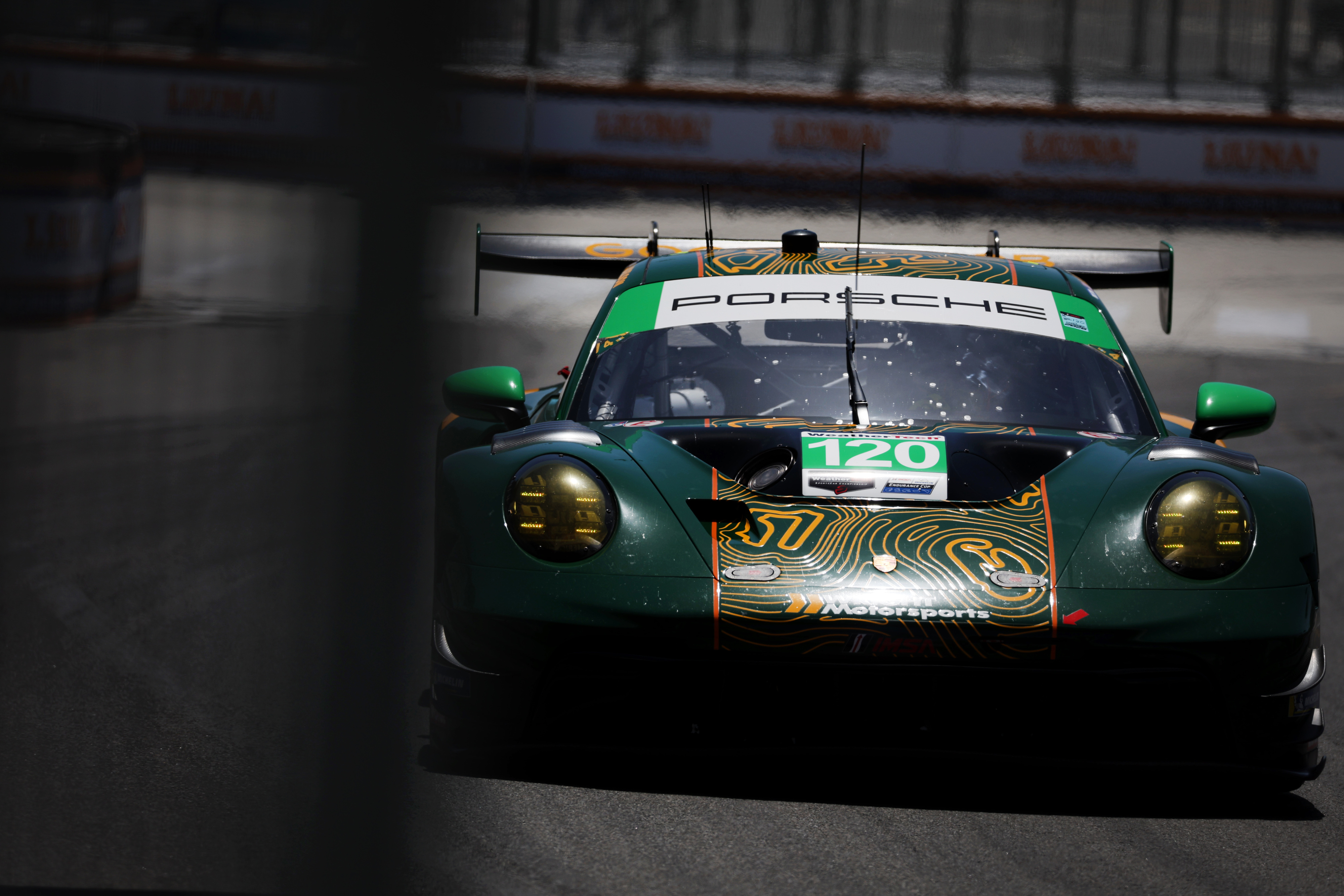 The Wright Motorsports GTD car races around the track in...