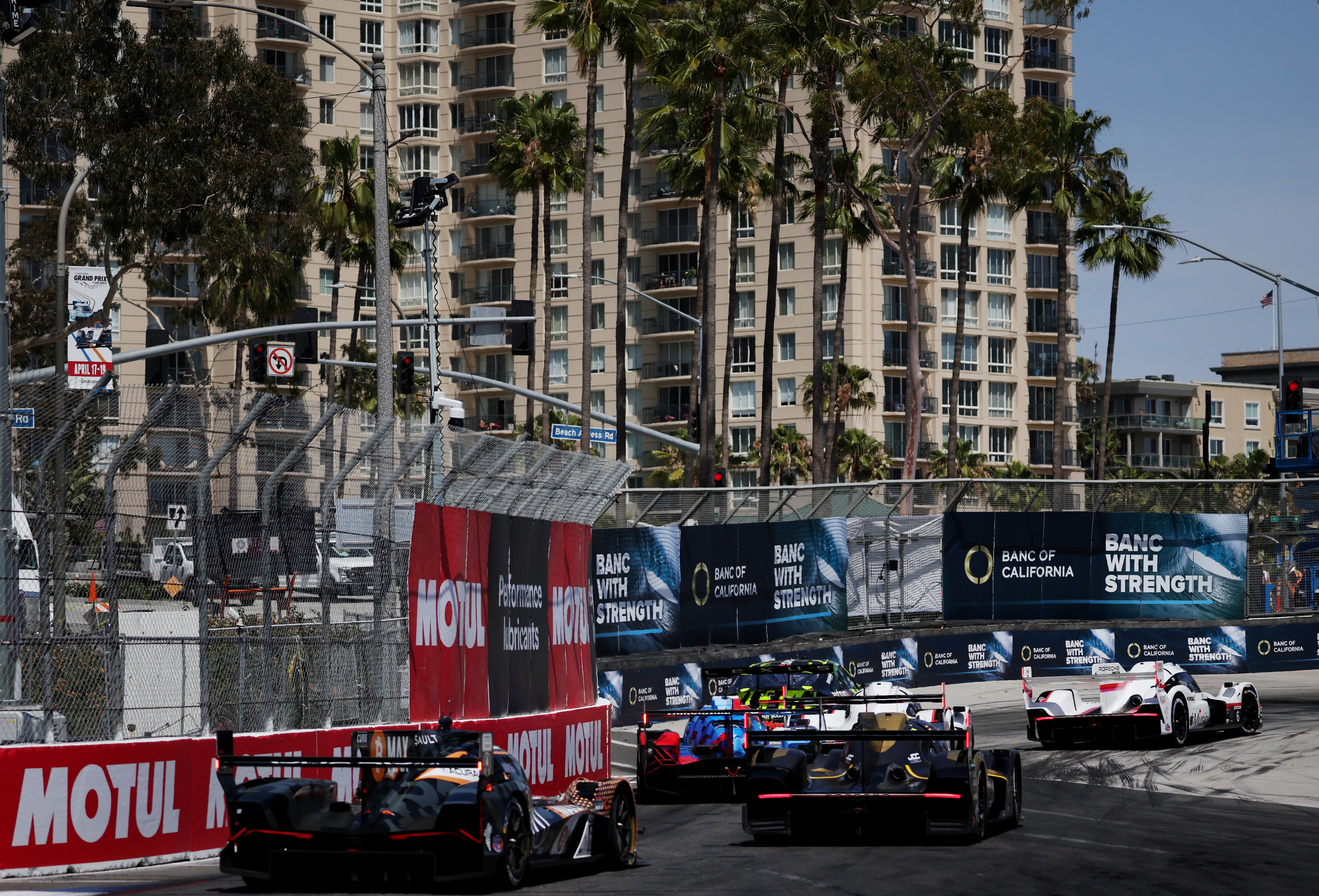 A group of GTP cars race into the hairpin in...