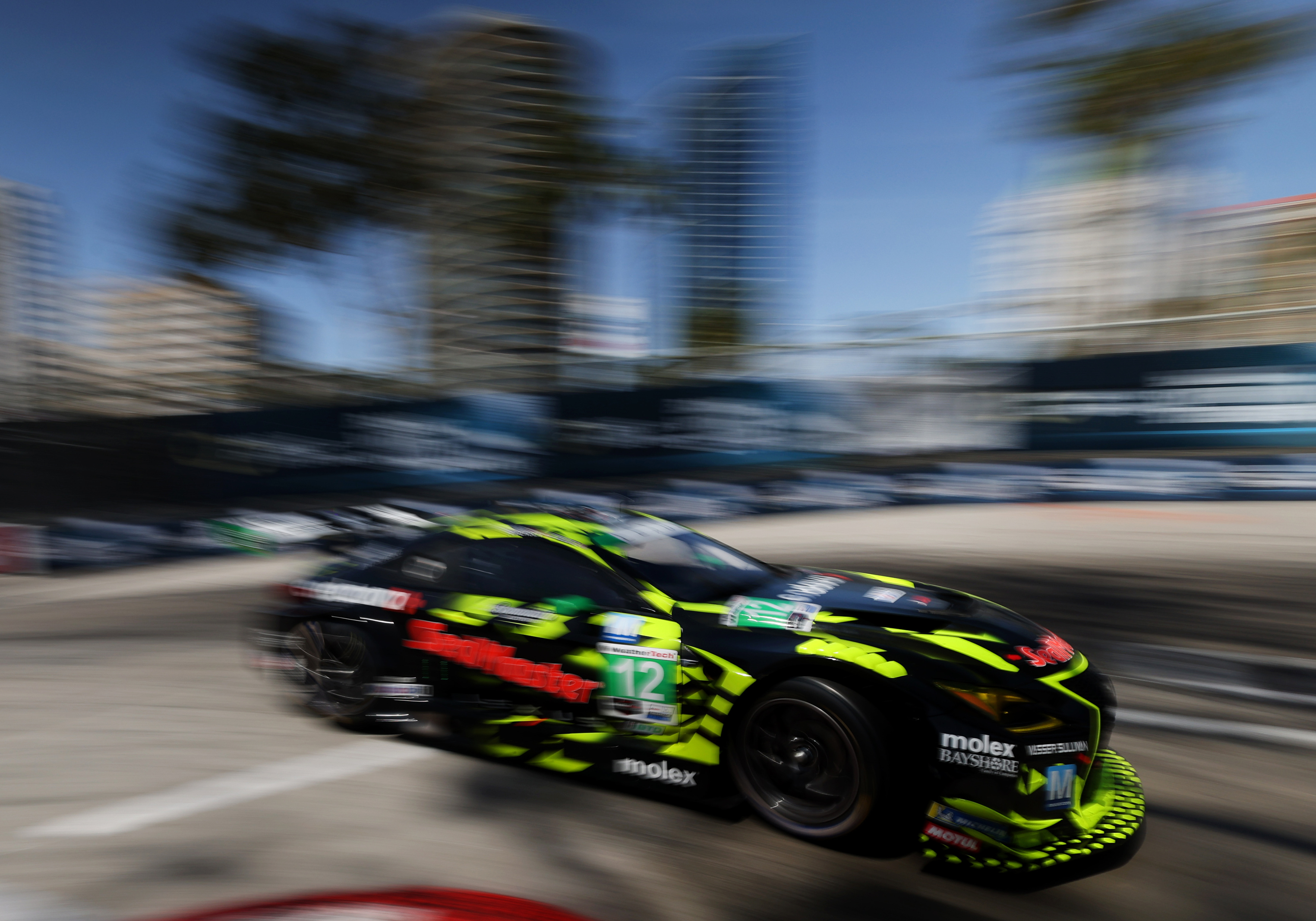 The Vasser Sullivan Racing GTD car (12) speeds through the...