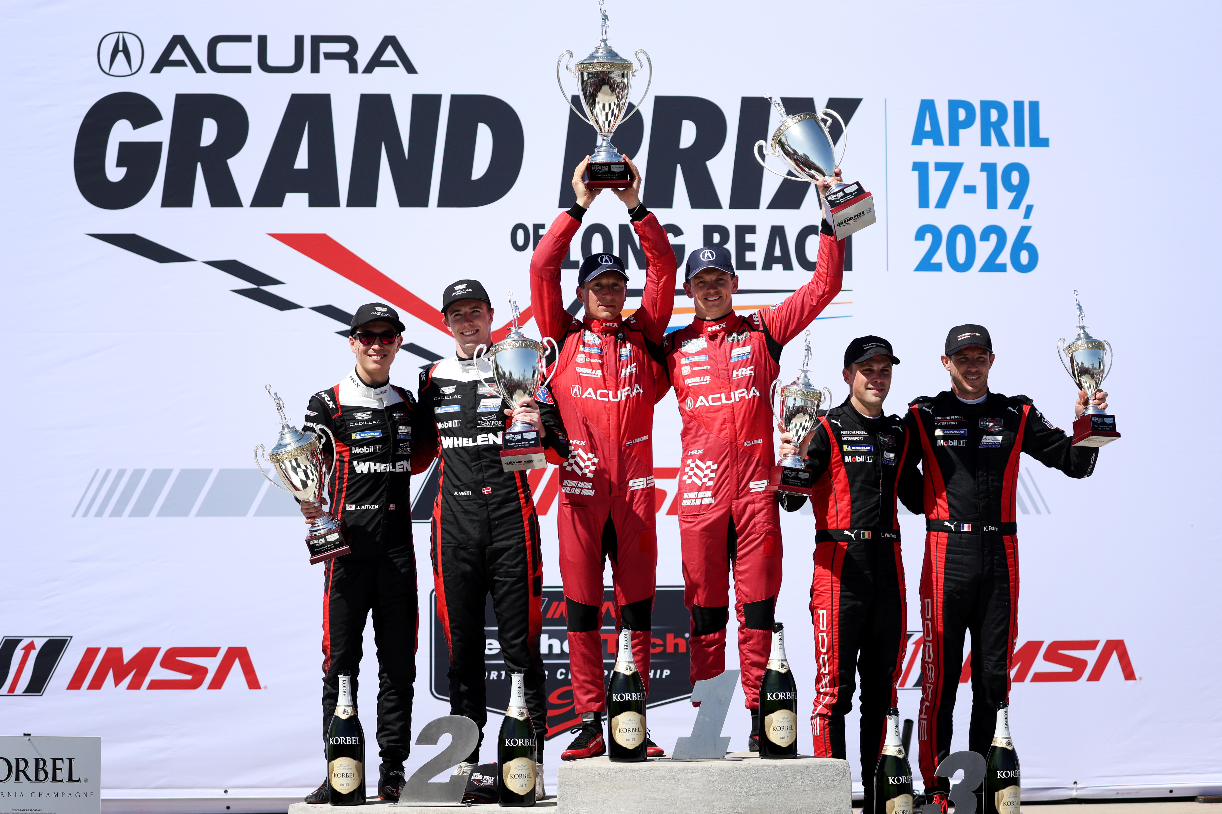 IMSA GTP winners, Renger van der Zande, center left, alongside...