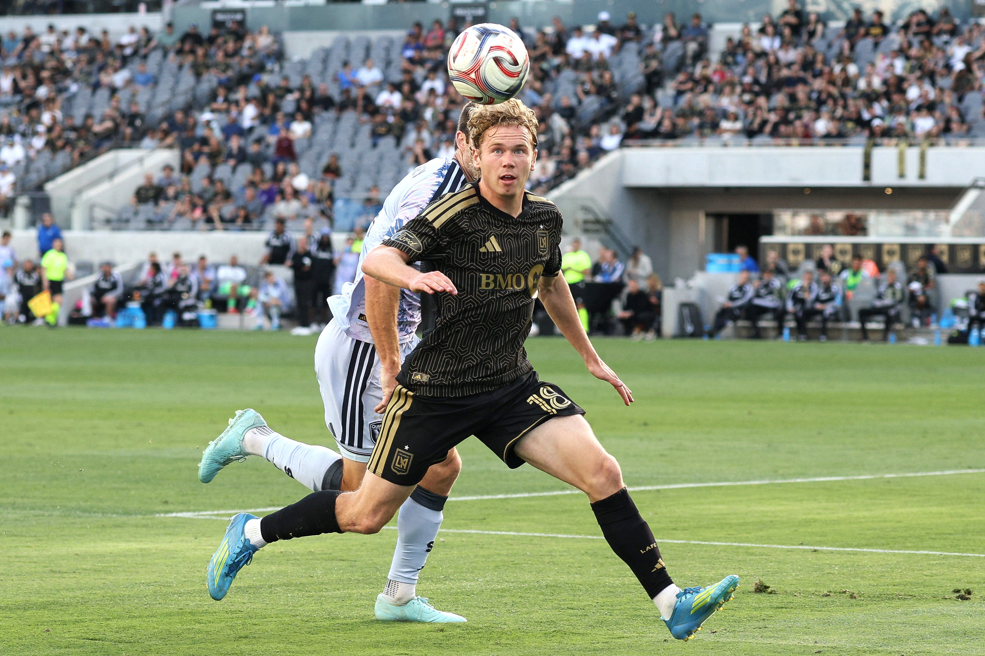 LAFC forward Jacob Shaffelburg, front, chases the ball down defended...