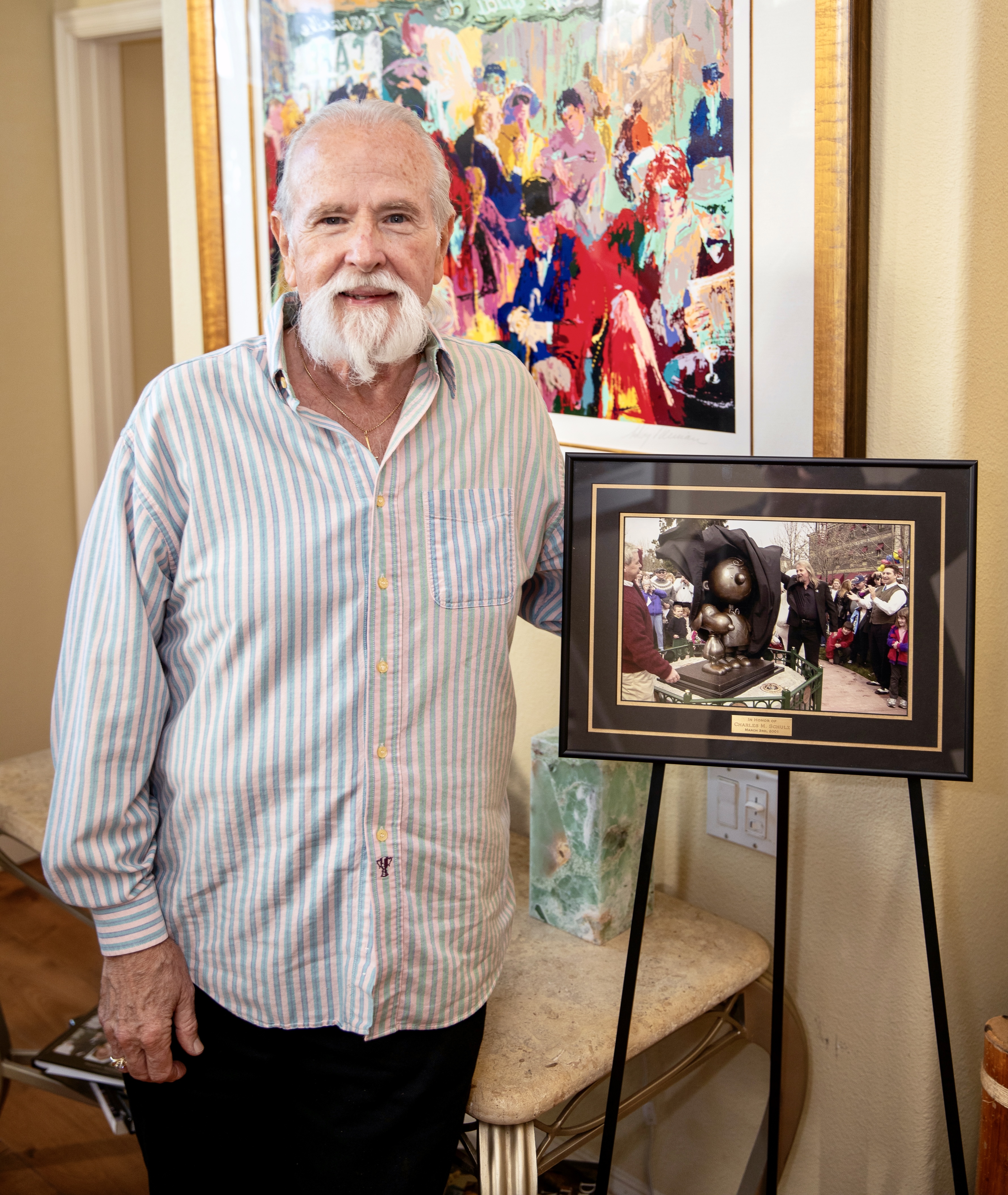 Stan Pawlowski stands by a photo of the unveiling of...