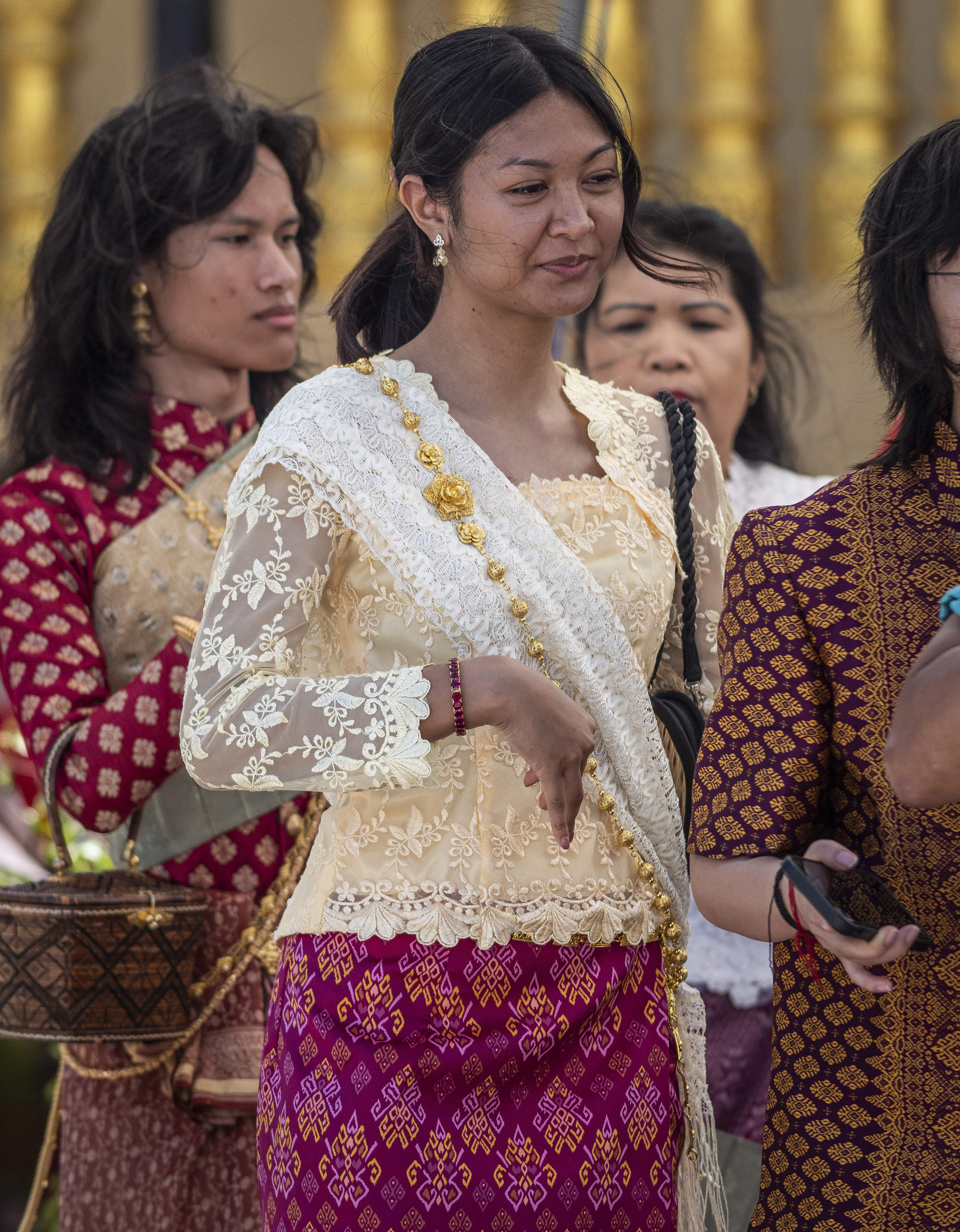 Verena Ke, 22, center wearing a traditional dress, dance with...