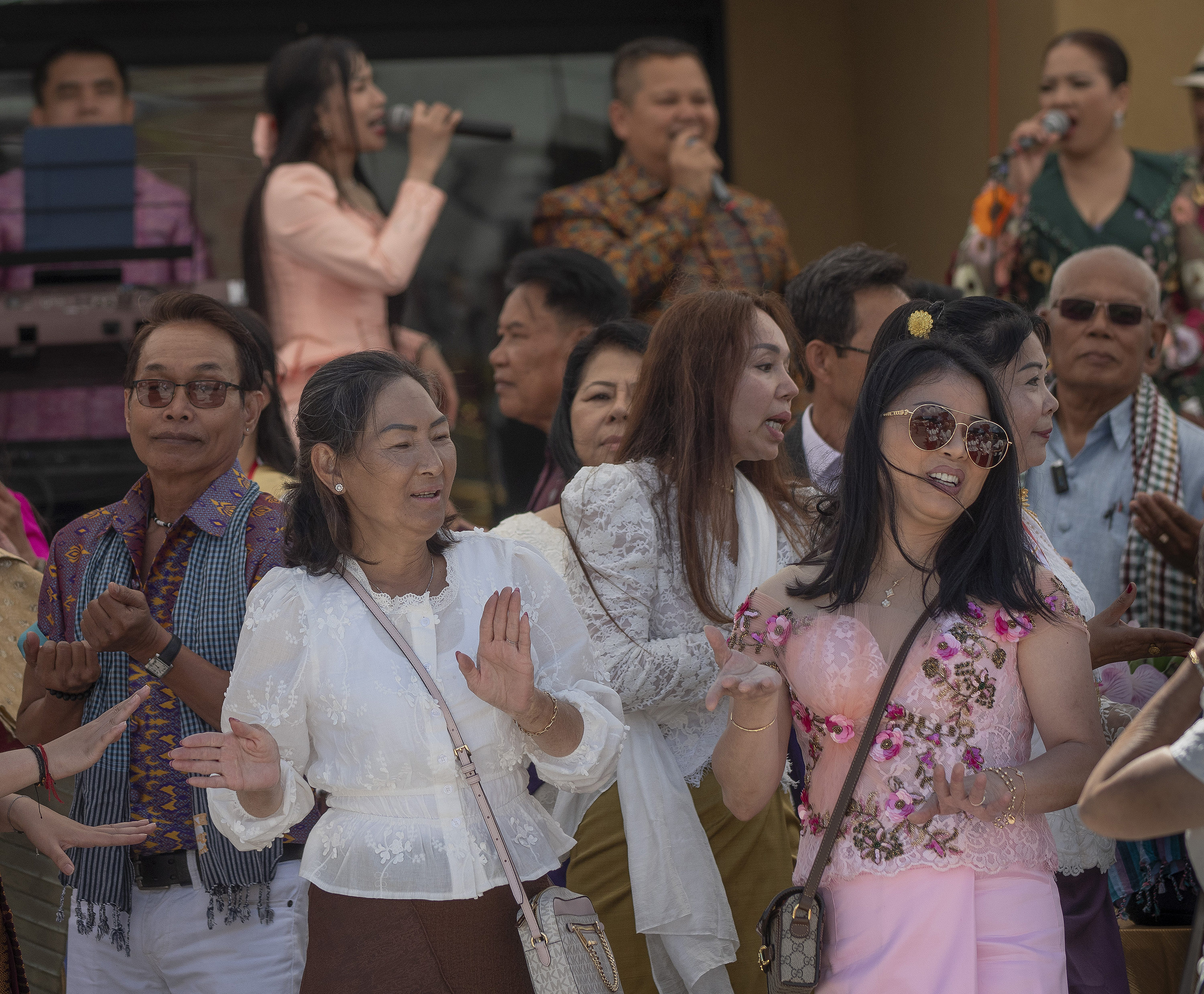 Attendees dance to traditional music during the Cambodian New Year...