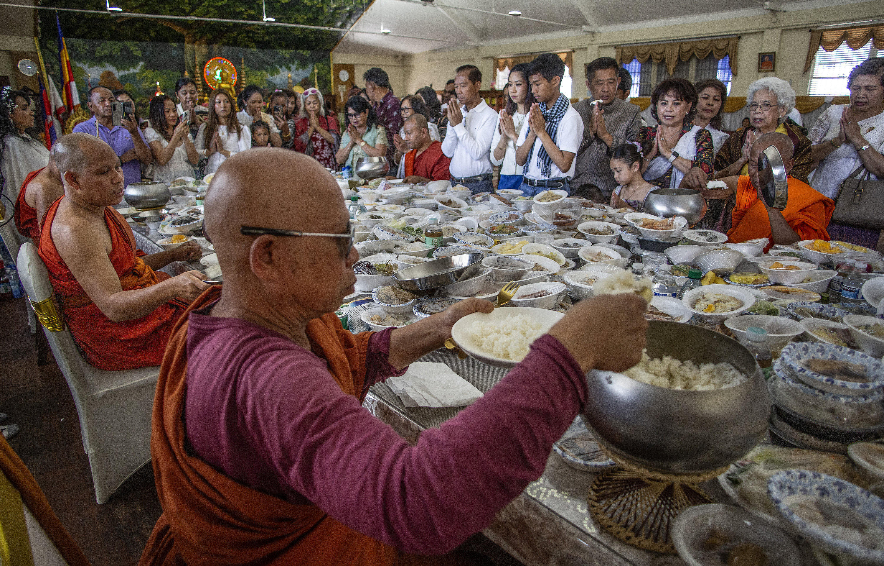 Head monk Som Saroun, far left, and other monks officiate...