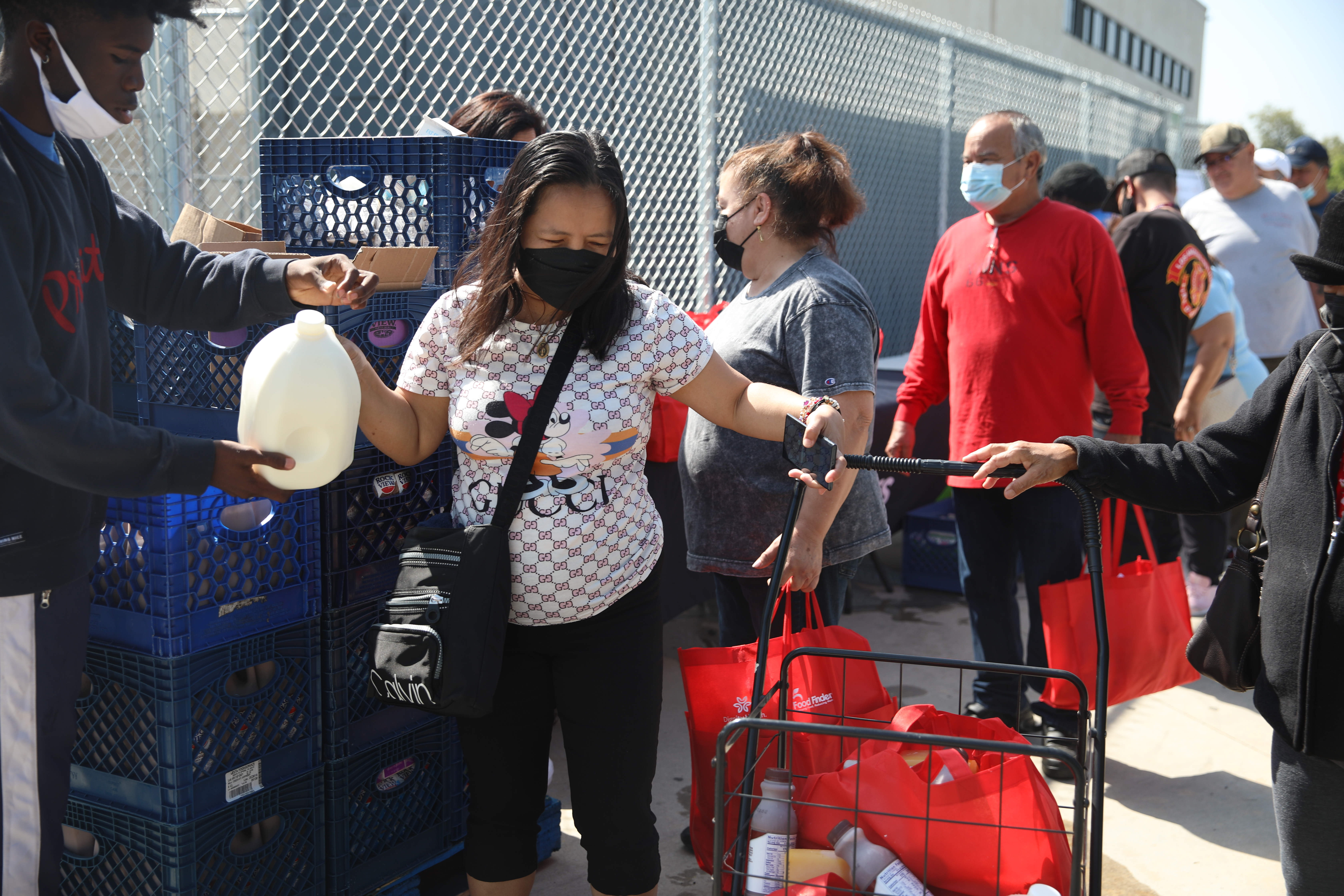People receive assorted food items on Saturday, Apr. 30, 2022,...