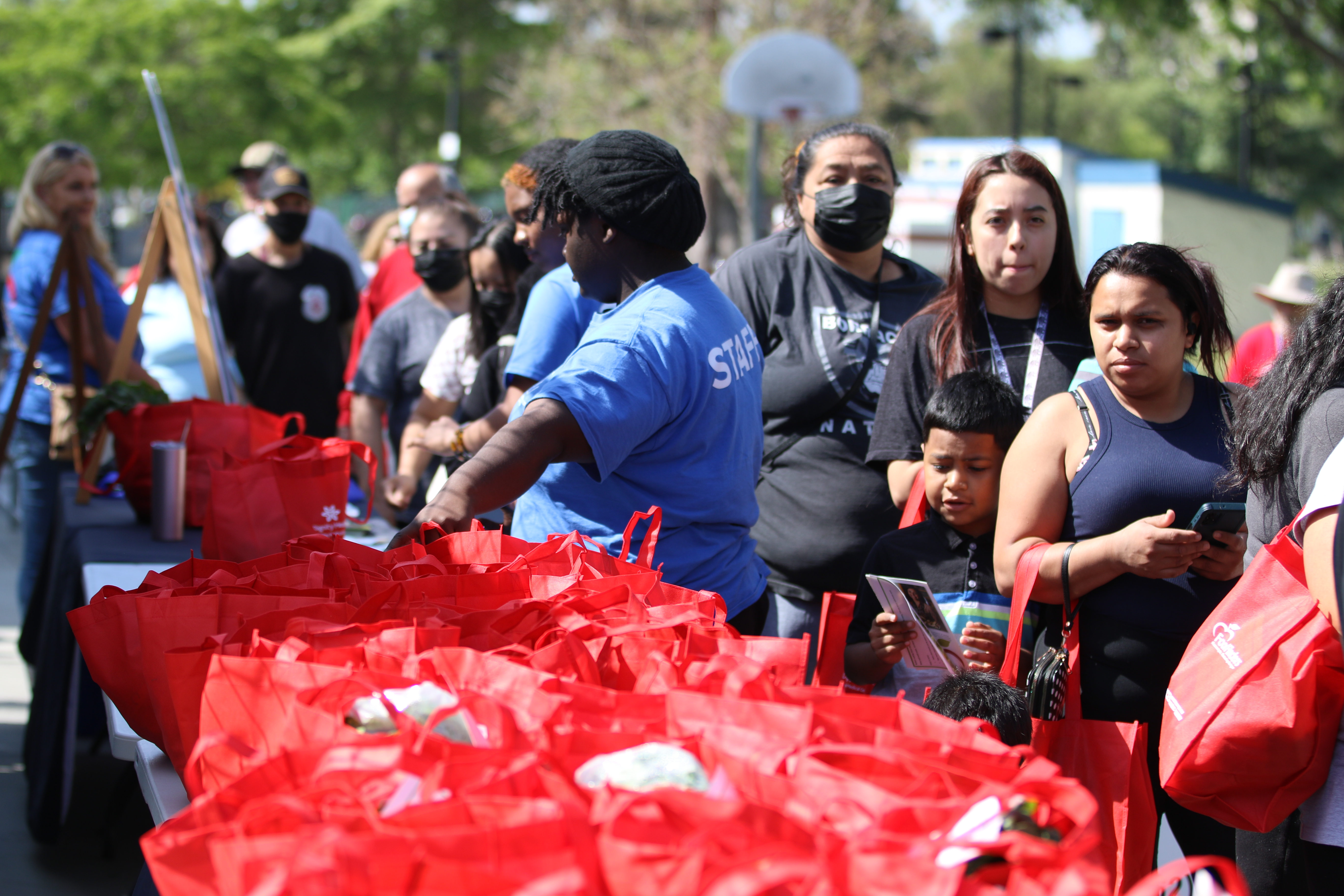 People line up to receive fresh and healthy food items...