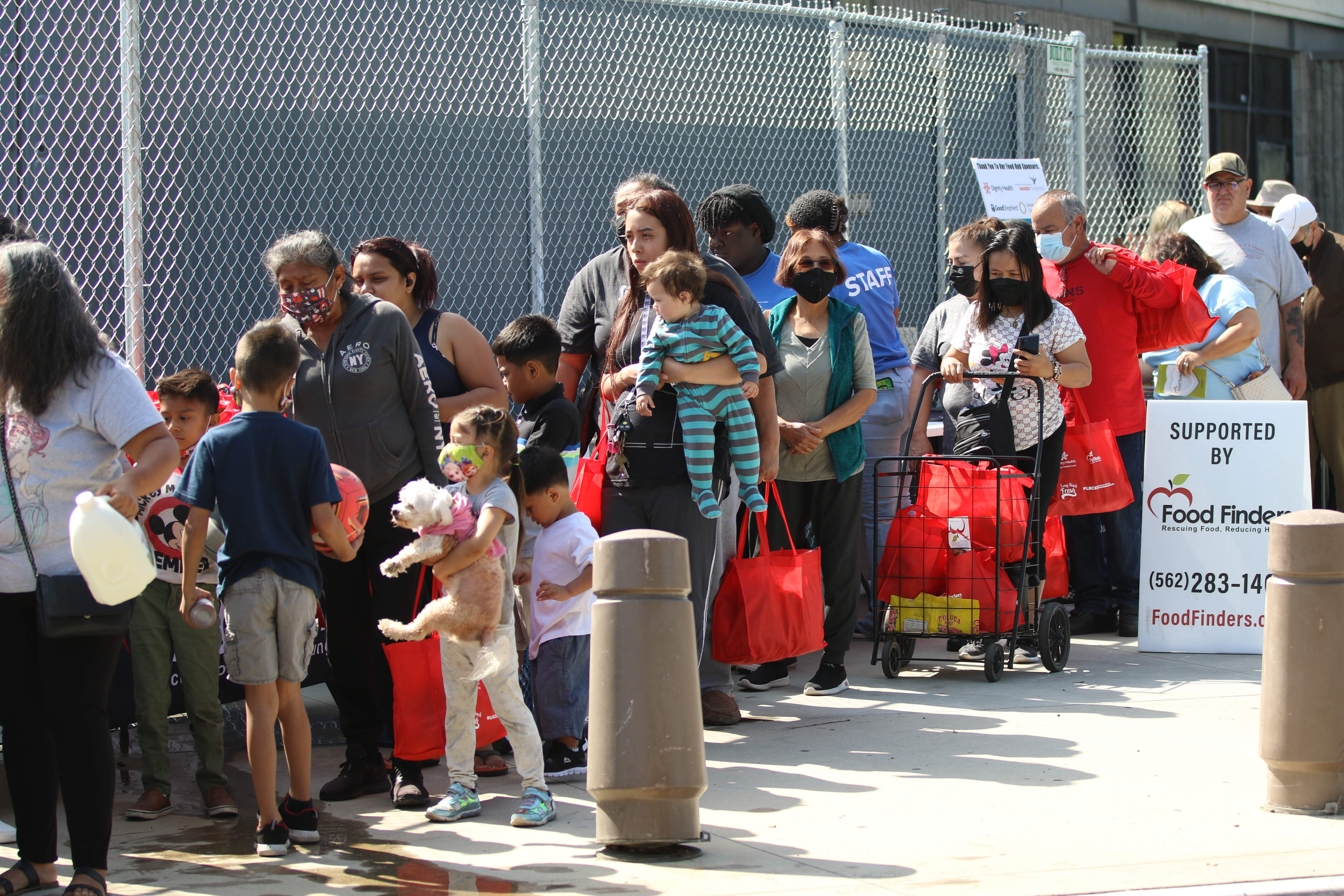 People receive assorted food items on Saturday, Apr. 30, 2022,...