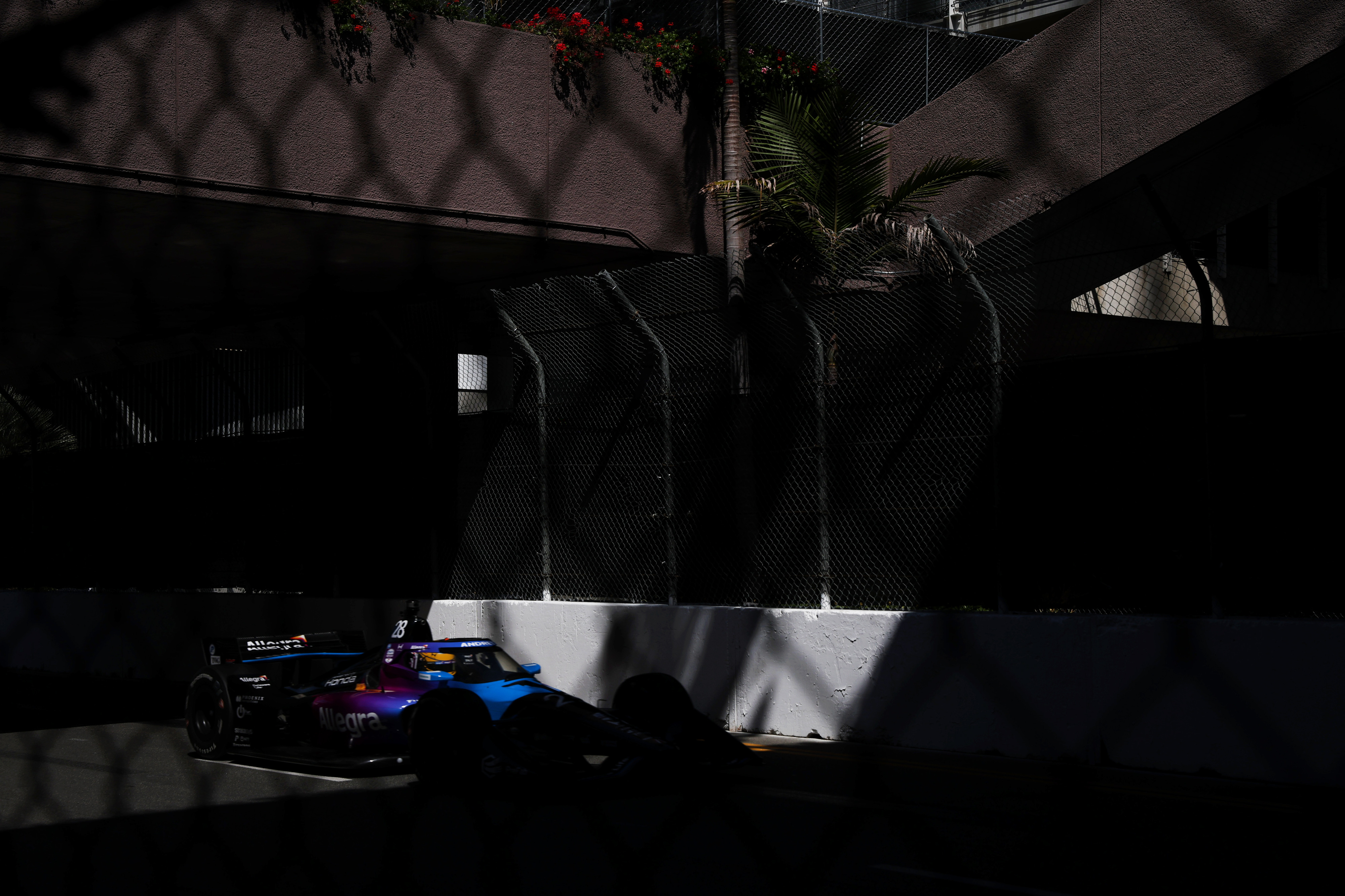Indycar driver Marcus Ericsson hustles down the back stretch in...