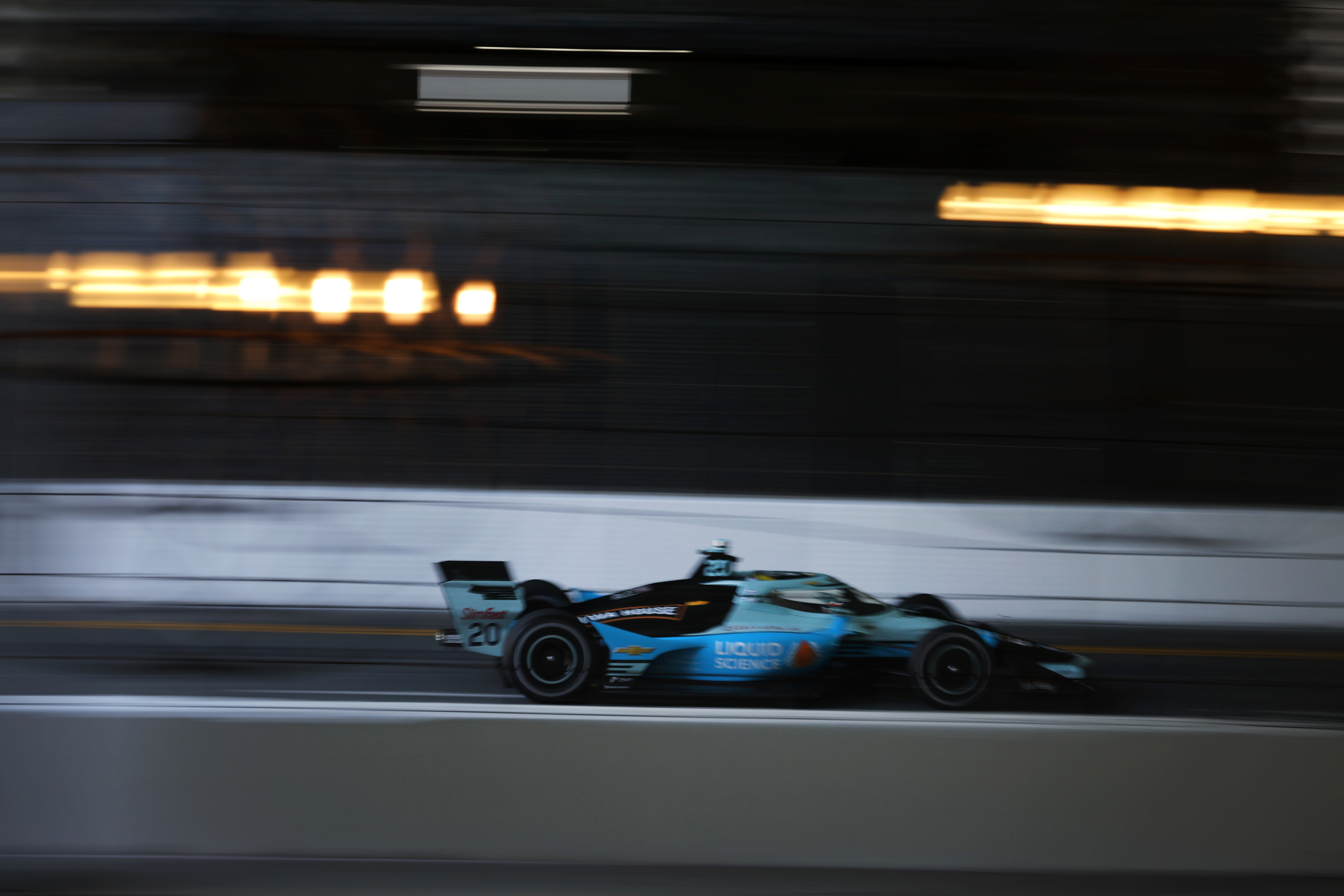 Indycar driver Alexander Rossi speeds down the backstretch in a...