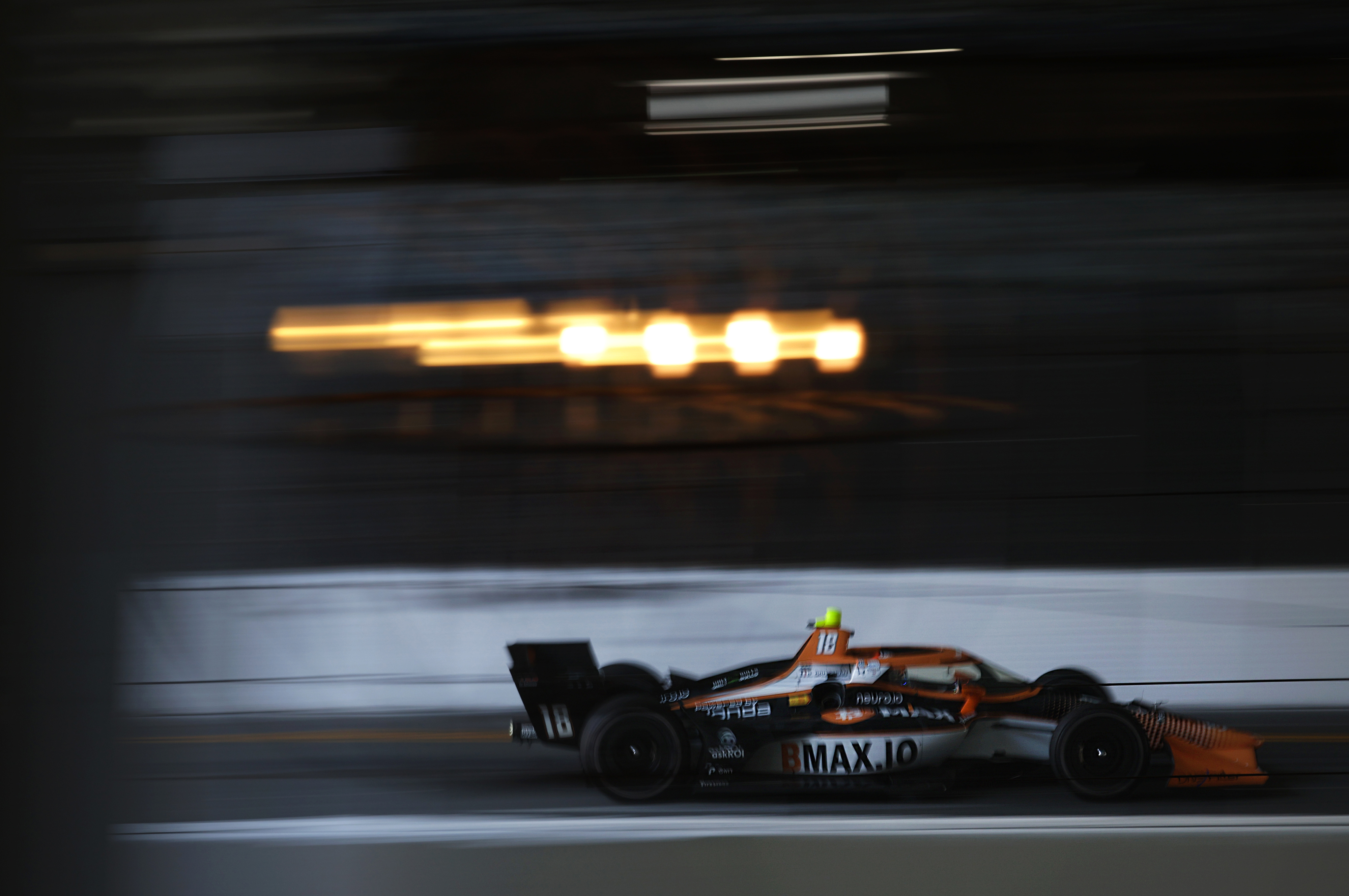 Indycar driver Romain Grosjean hustles down the back stretch in...