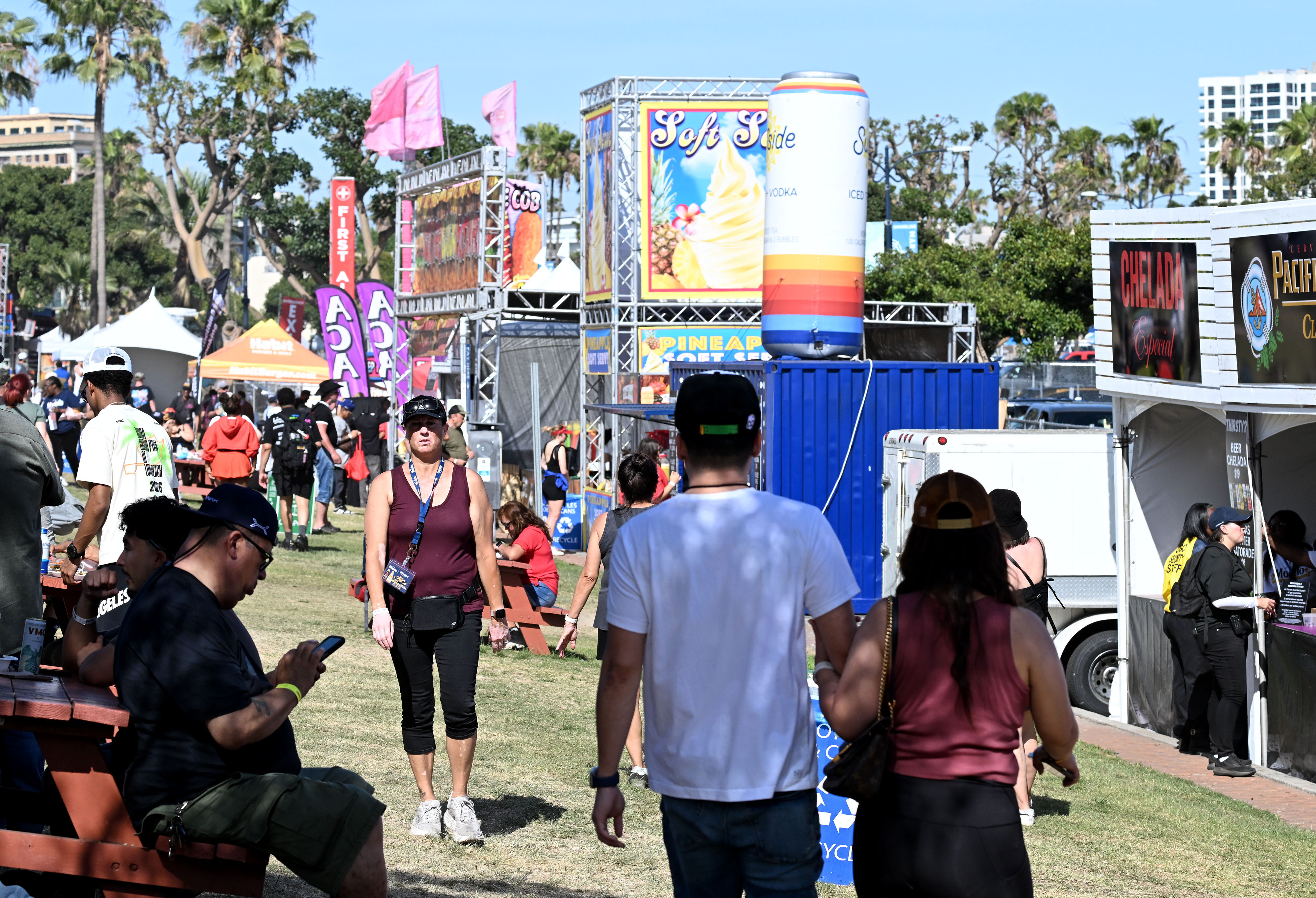 People relax between race events in the food area behind...