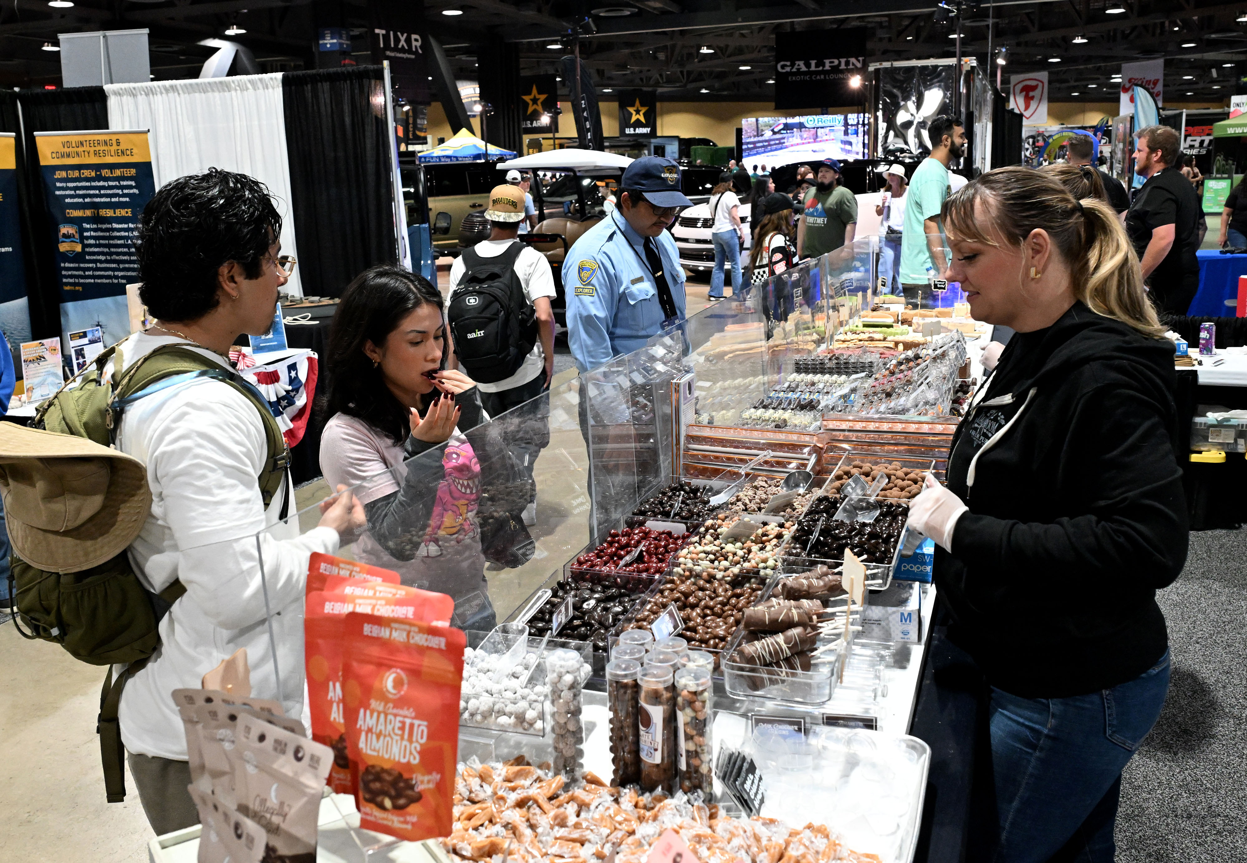 Race fans taste chocolate at the Chocolate Moonshine Company booth...