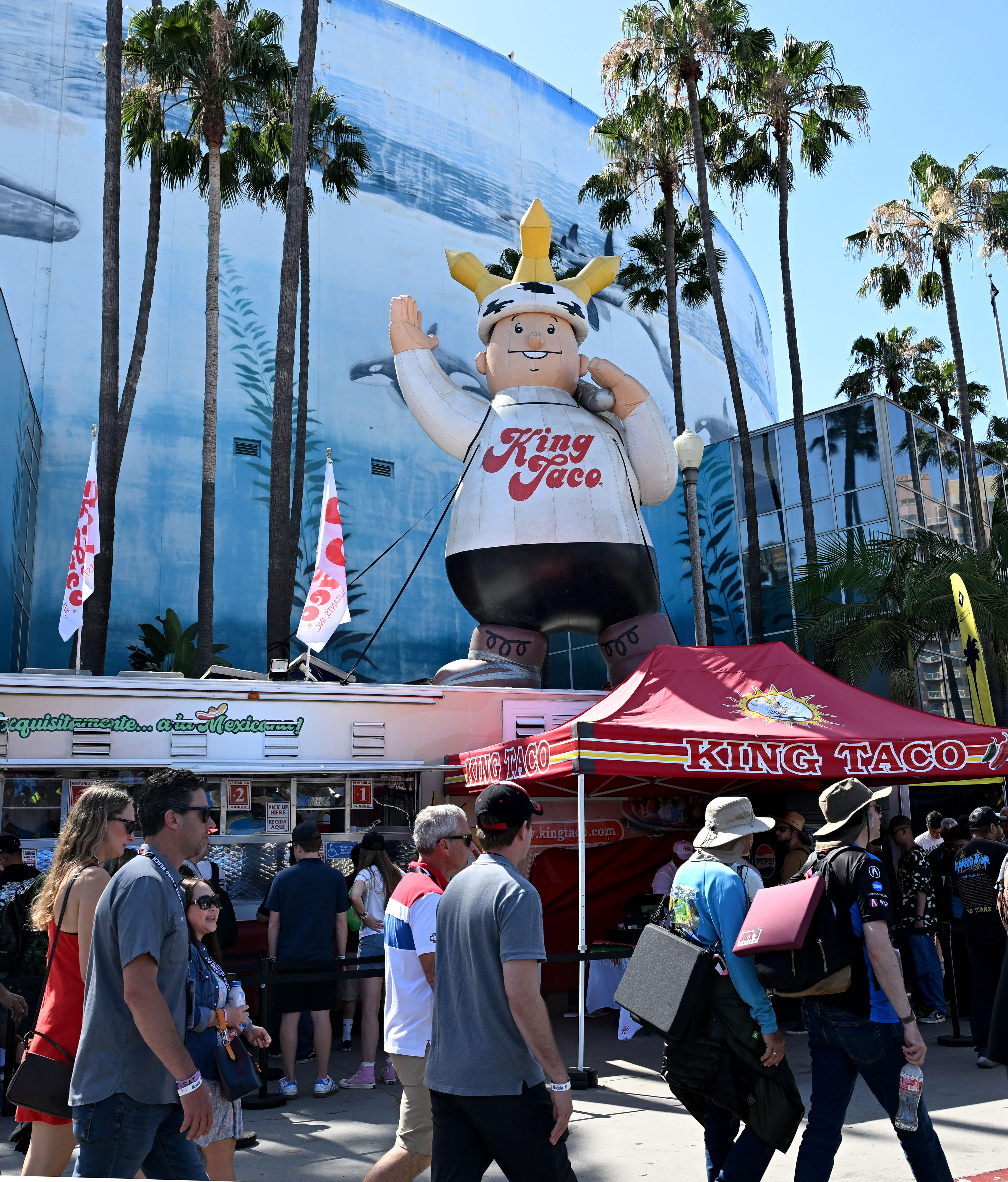 Race fans pass the King Taco stand during the 51st...
