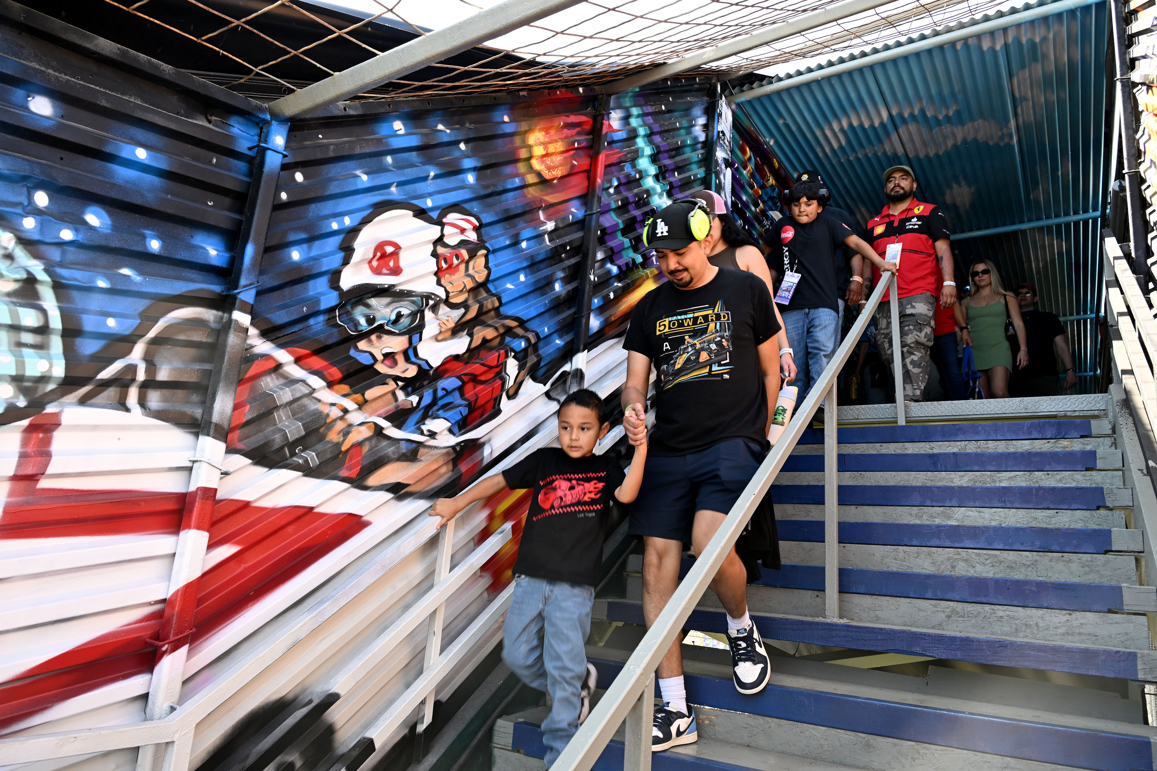 Race fans exit one of the pedestrian bridges during the...