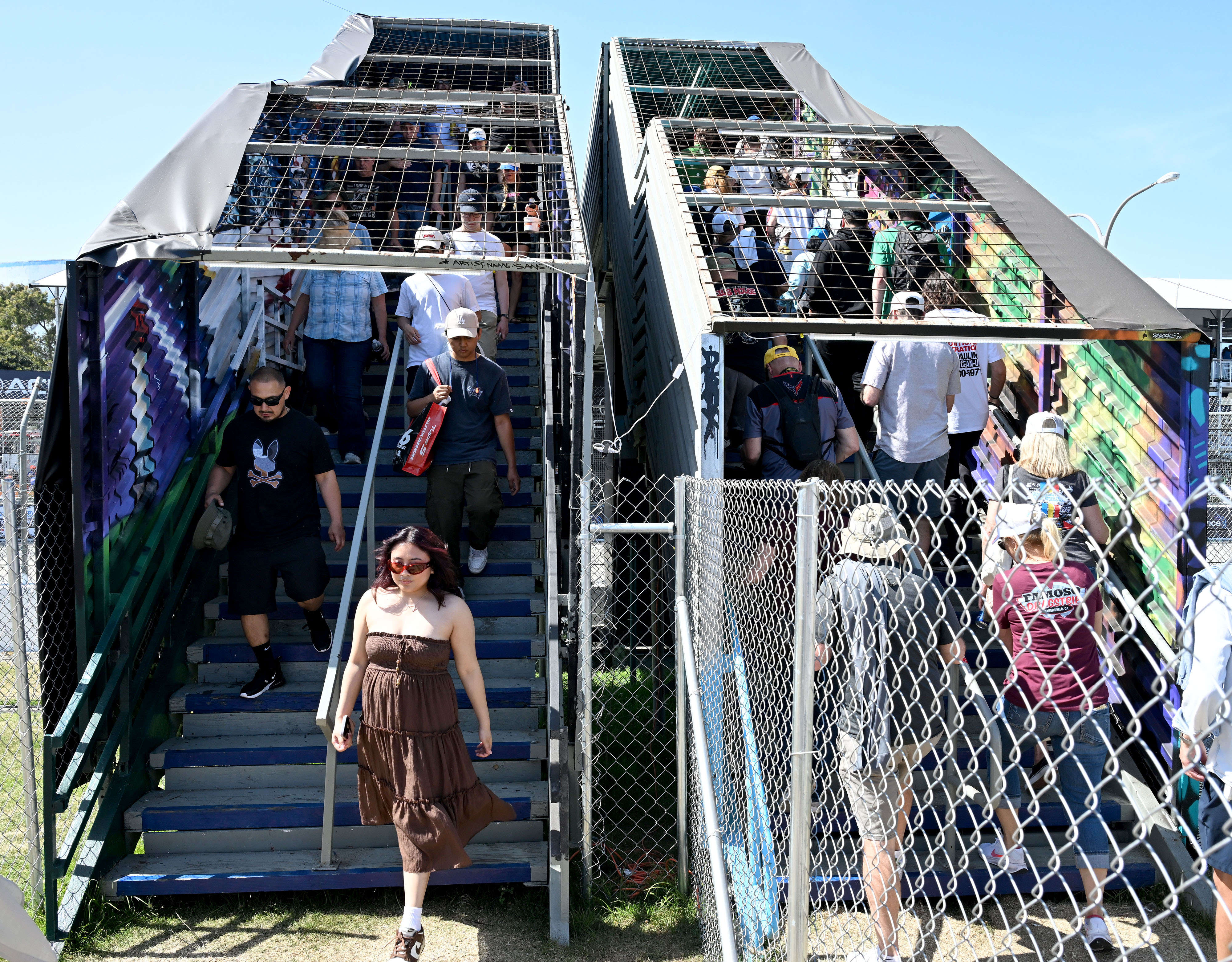 Race fans move along a pedestrian bridge during the 51st...