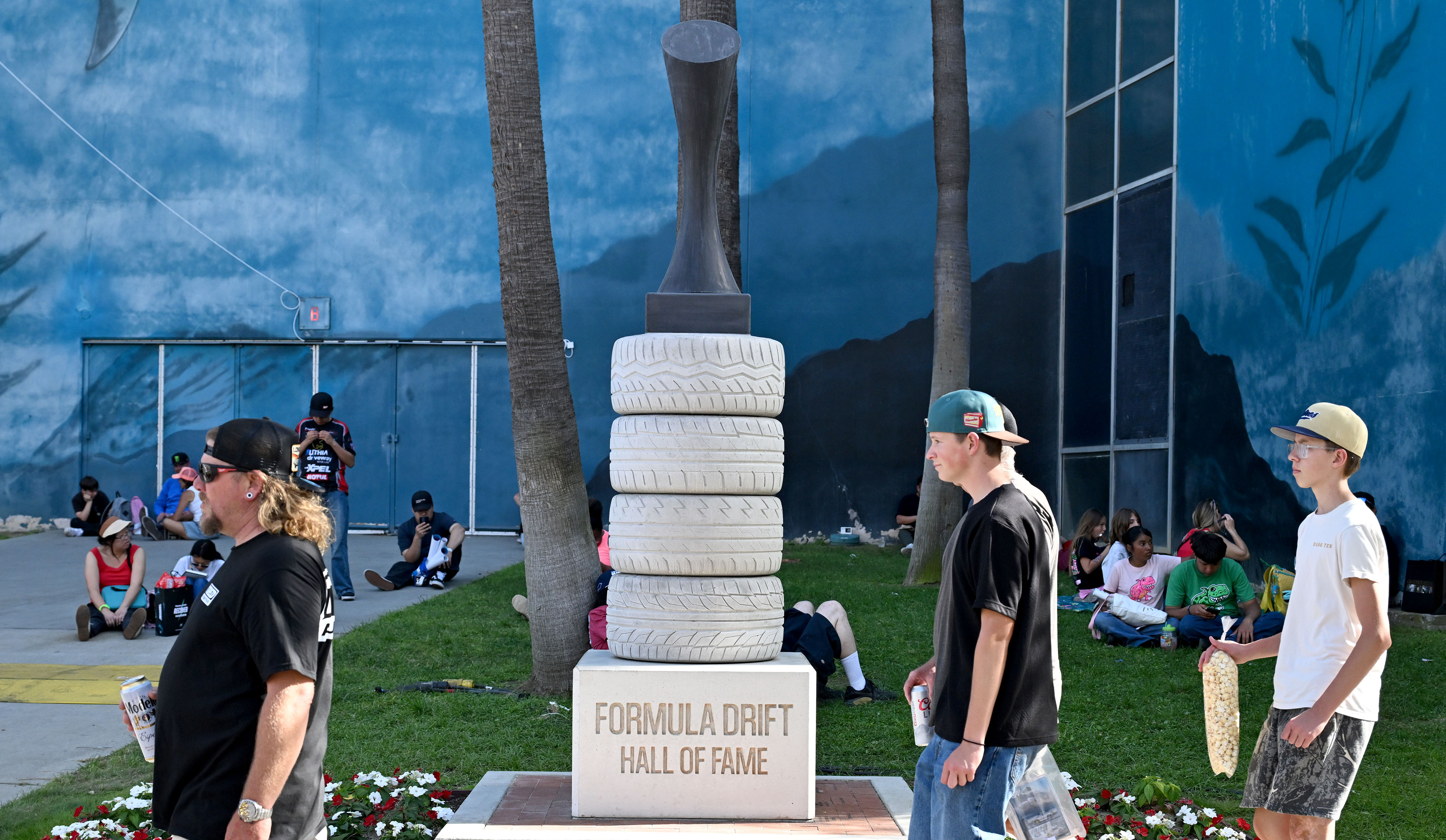 Race fans walk past the Formula Draft Hall Of Fame...