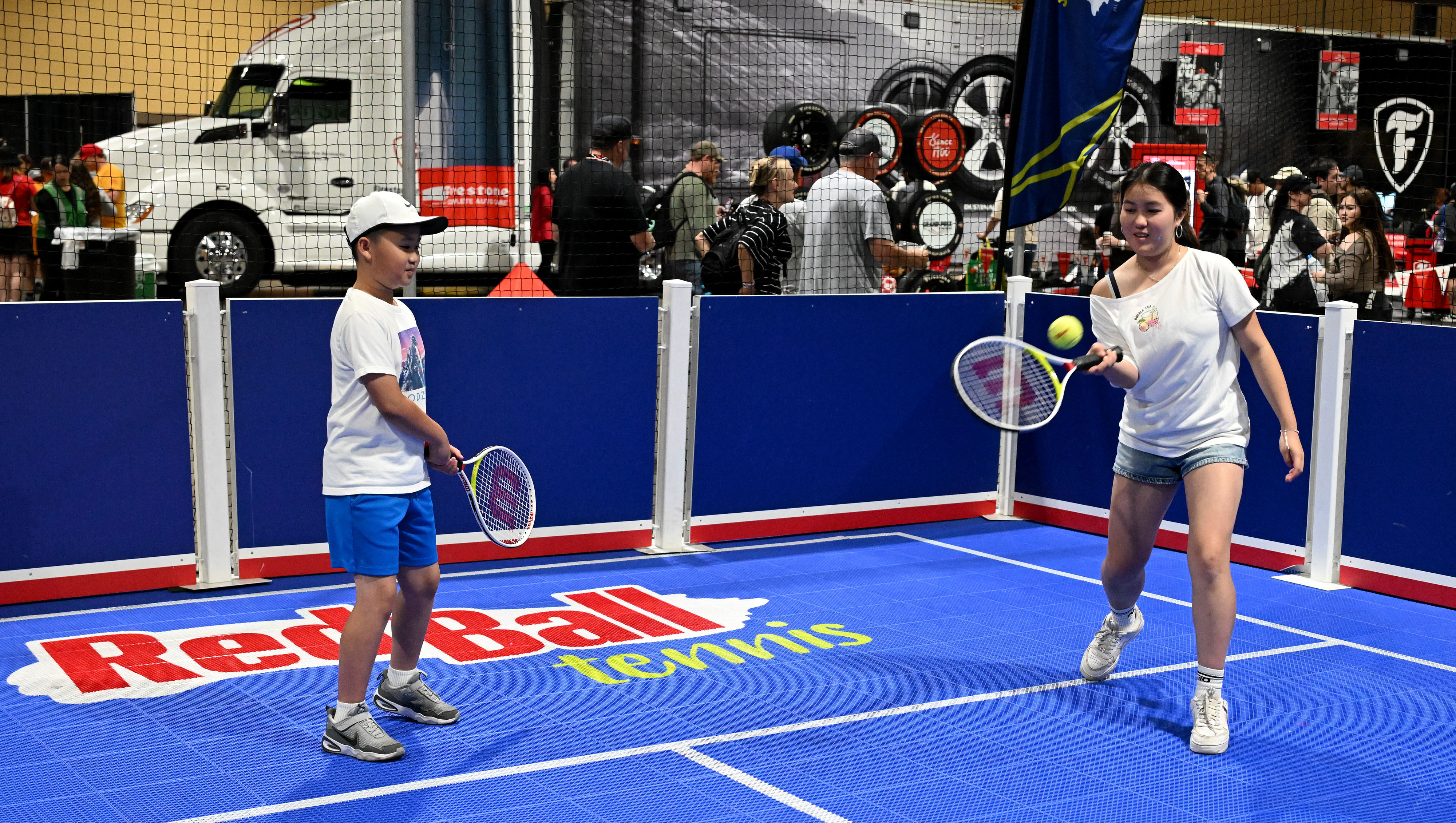 Race fans try out a game of Red Ball Tennis...