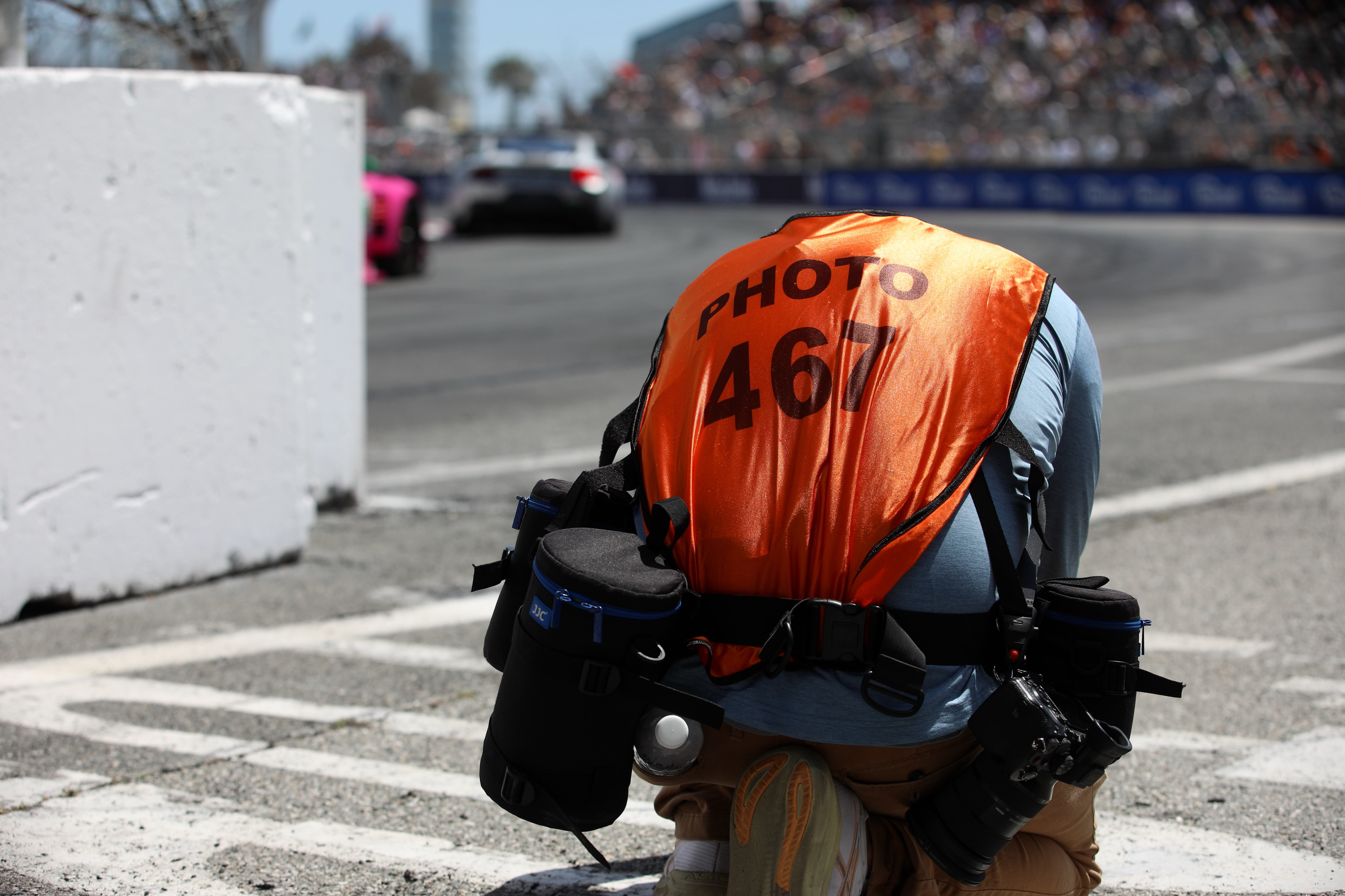 A photographer crouches down to get a low angle perspective...
