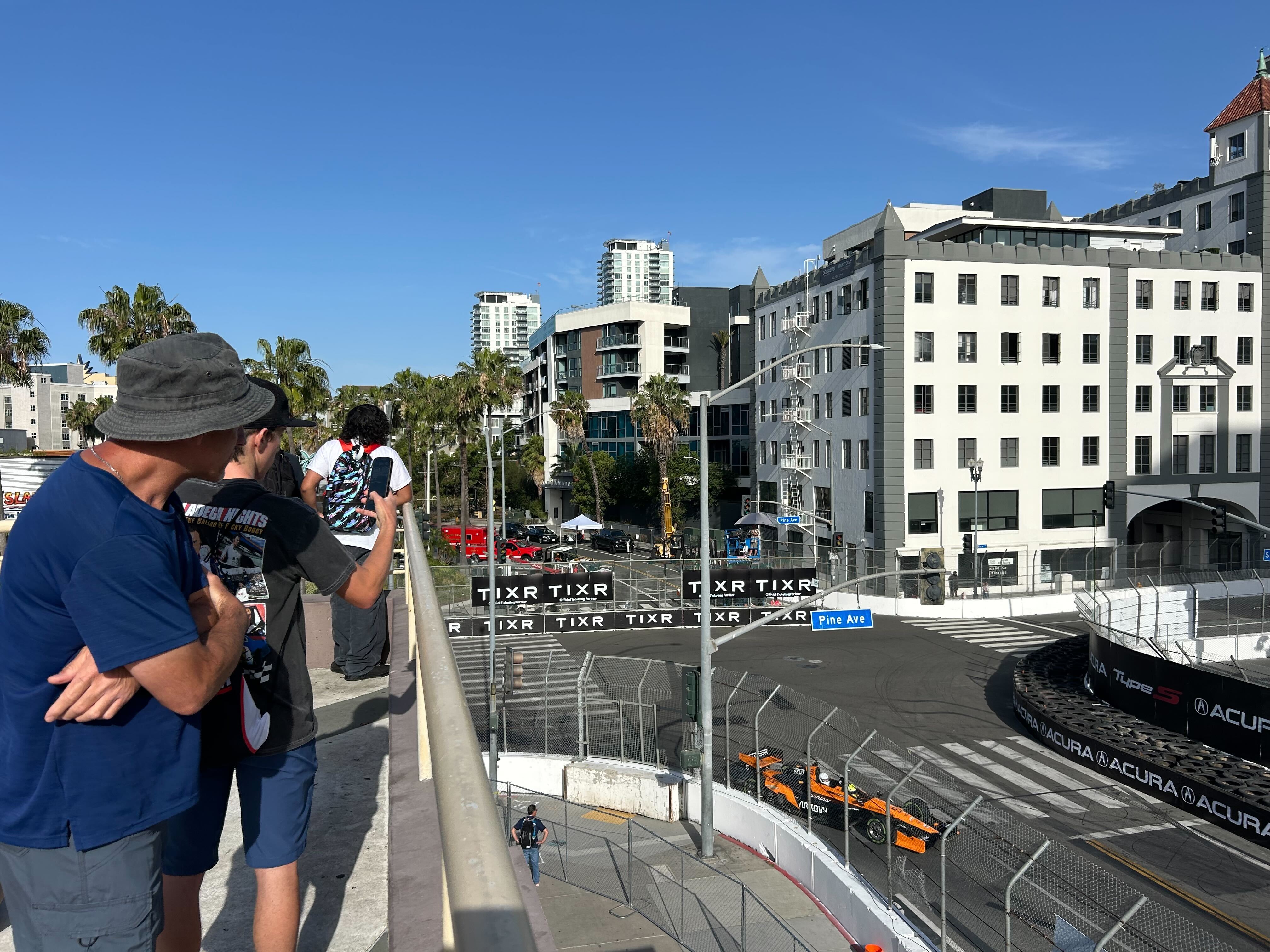 Early bird fans watch race cars zip around the 1.97-mile...