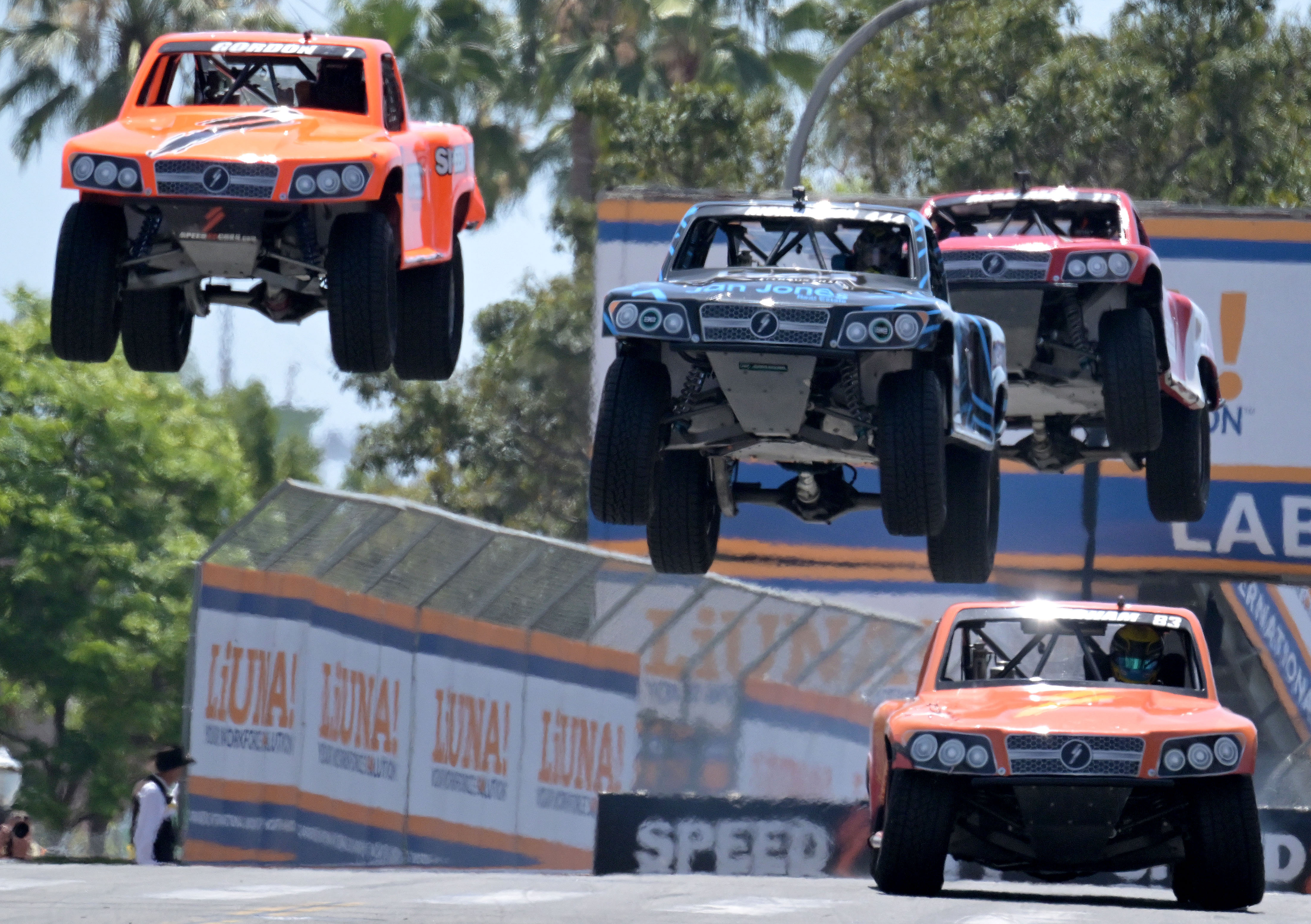 Stadium Super Truck drivers Matt Brabham, front right, Robby Gordon,...