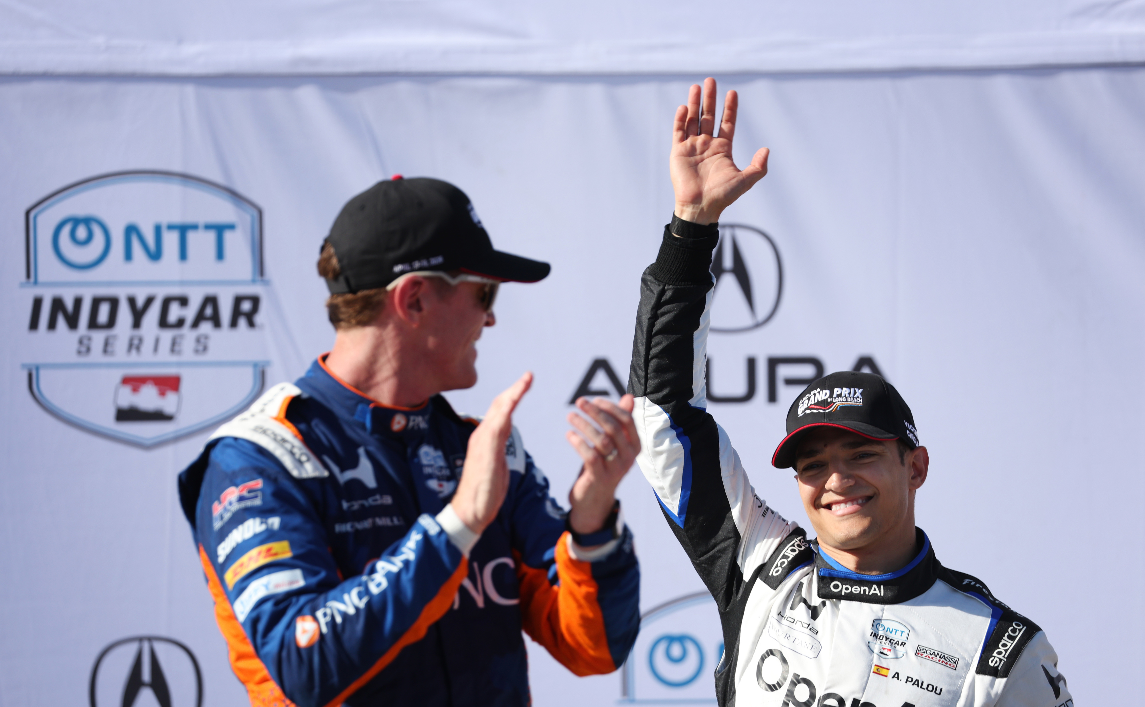 Indycar driver Alex Palou, right, waves behind Scott Dixon after...